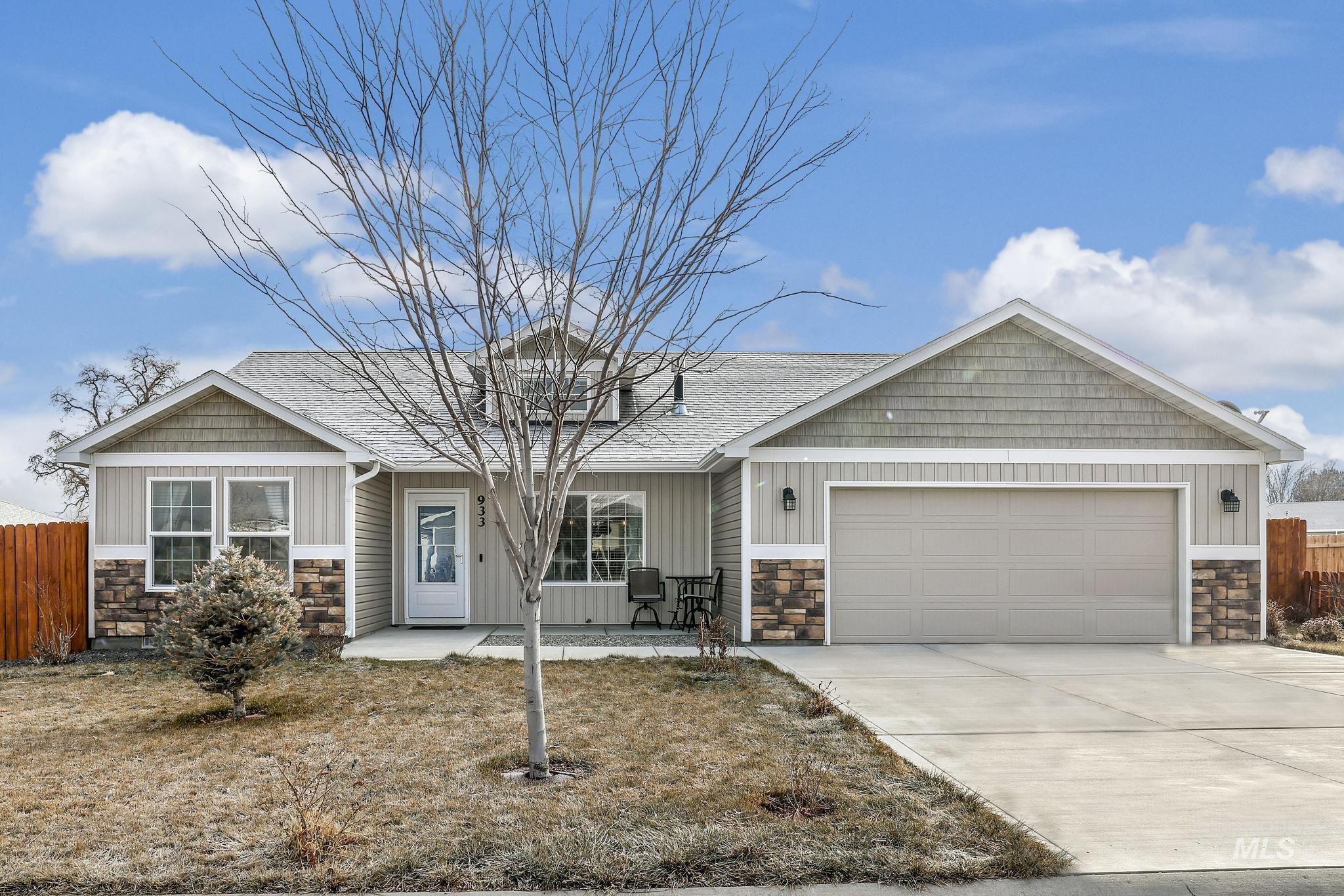 Craftsman house featuring stone siding, driveway, an attached garage, and roof with shingles