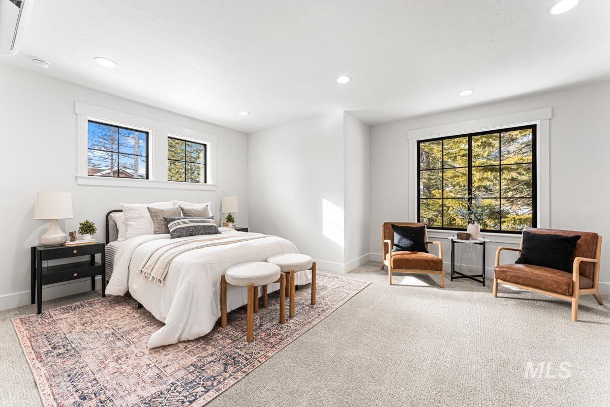 Carpeted bedroom with recessed lighting and cooling unit