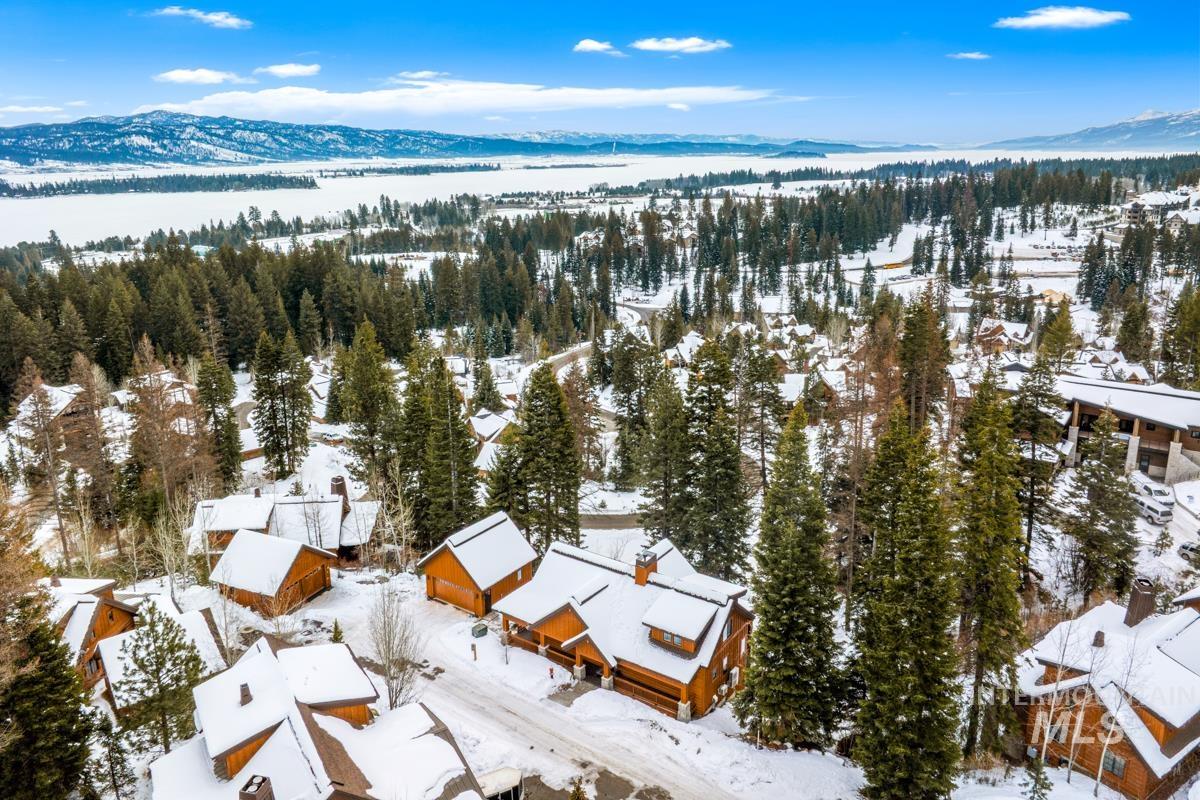 Snowy aerial view with a water and mountain view