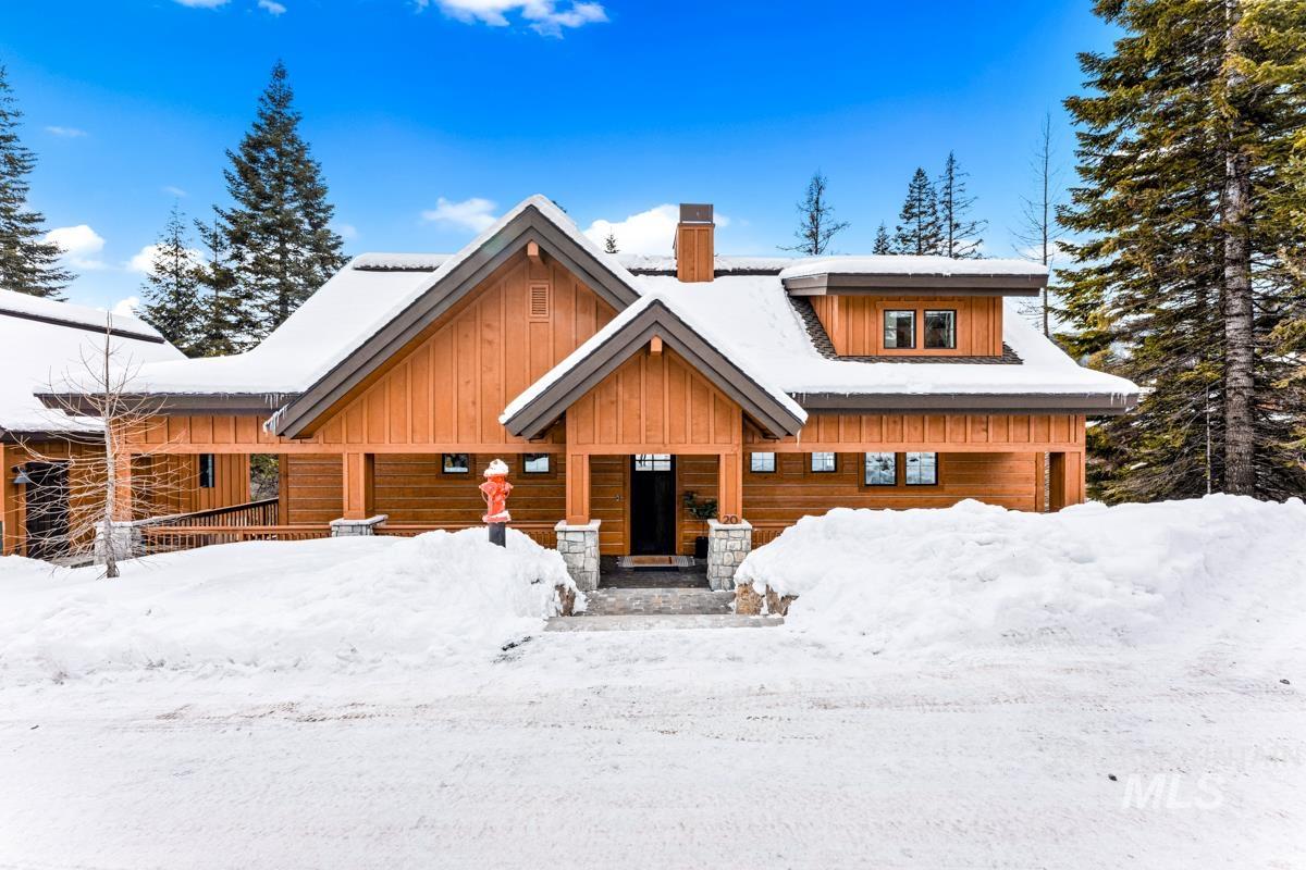 View of front of home with a chimney and board and batten siding
