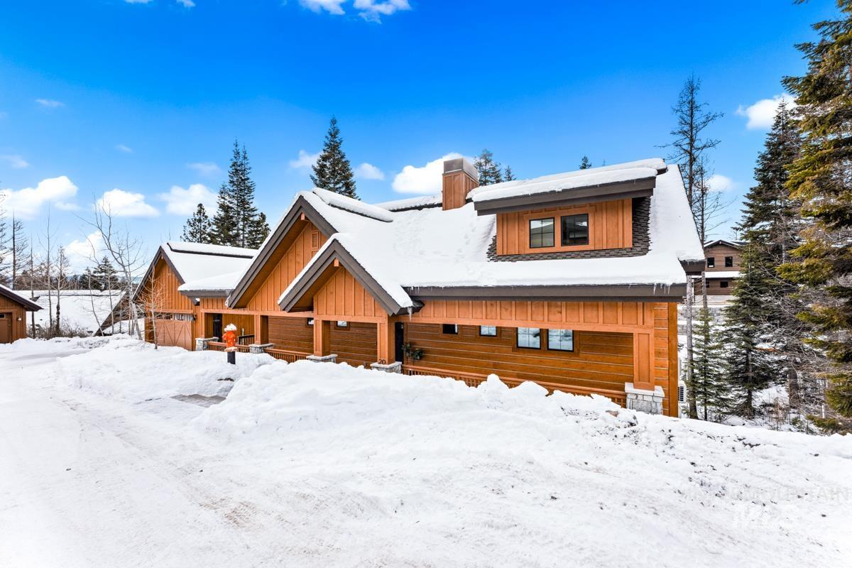 View of front of house featuring a chimney and board and batten siding
