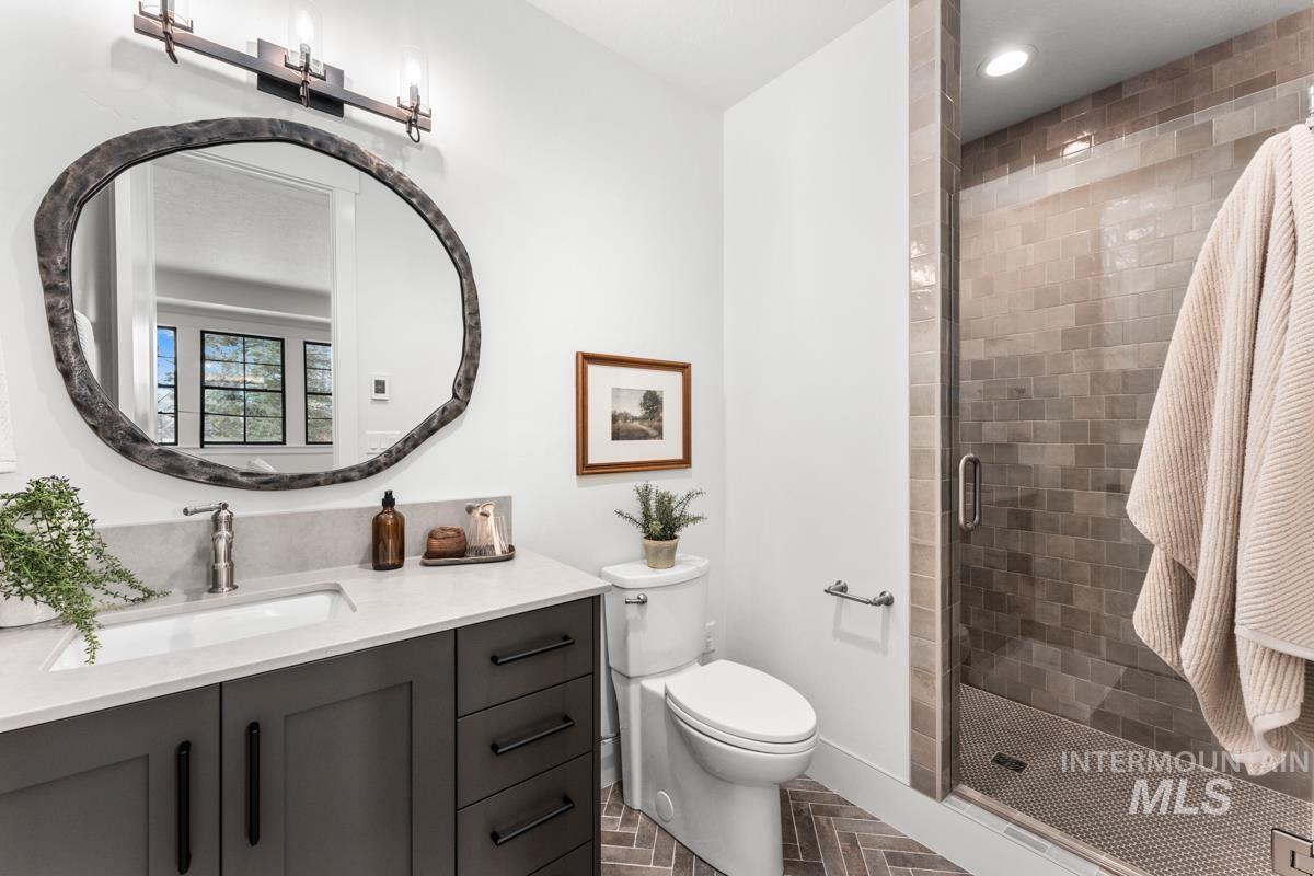 Bathroom with vanity, a stall shower, and recessed lighting
