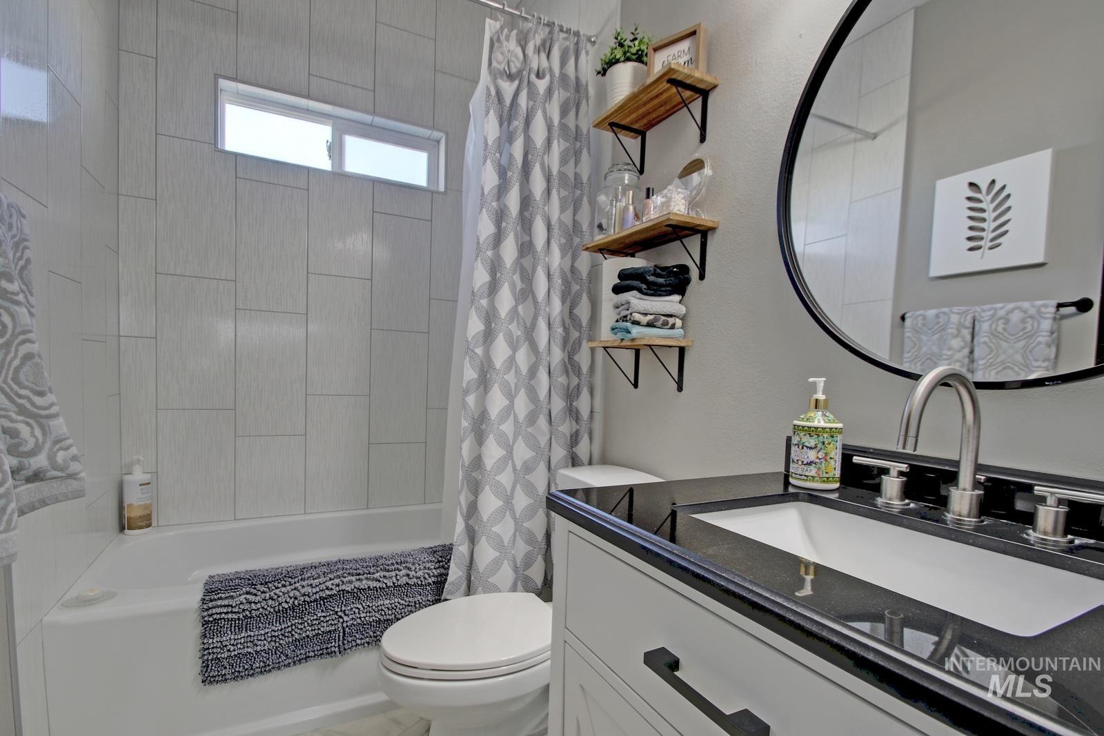Full bathroom featuring shower / tub combo and vanity
