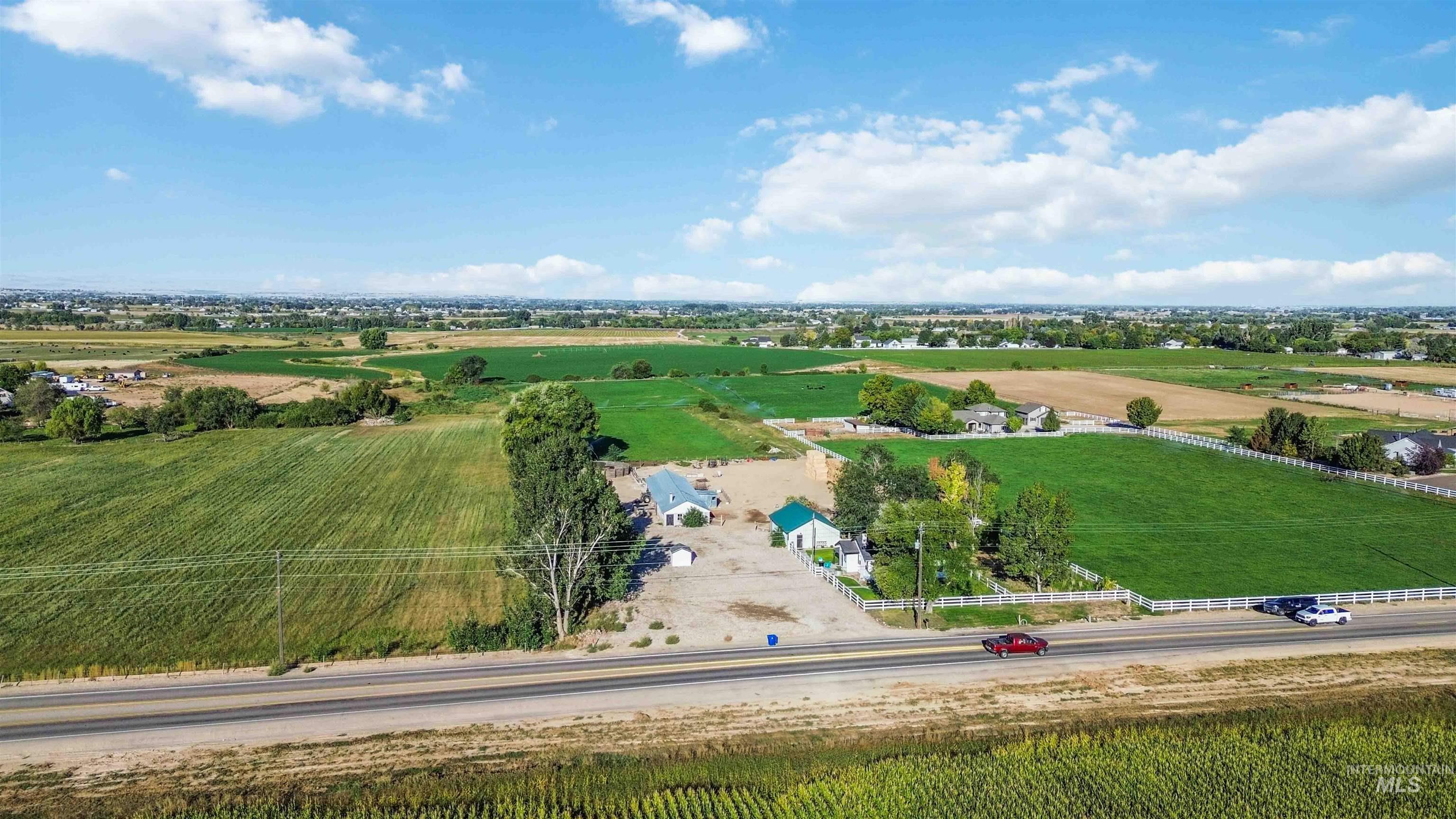 Overview of rural landscape featuring large plots for crops