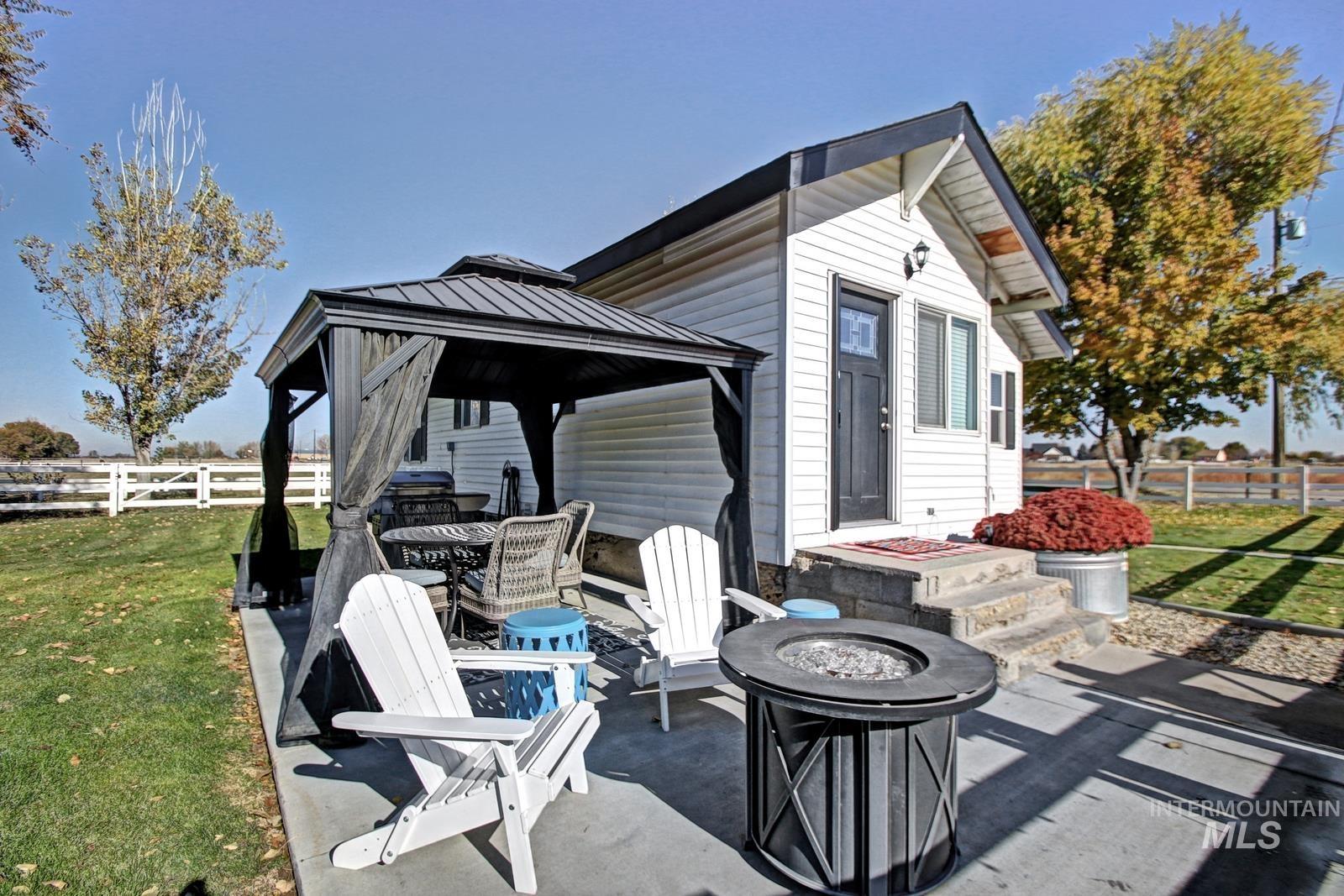 View of patio featuring a gazebo and an outdoor fire pit
