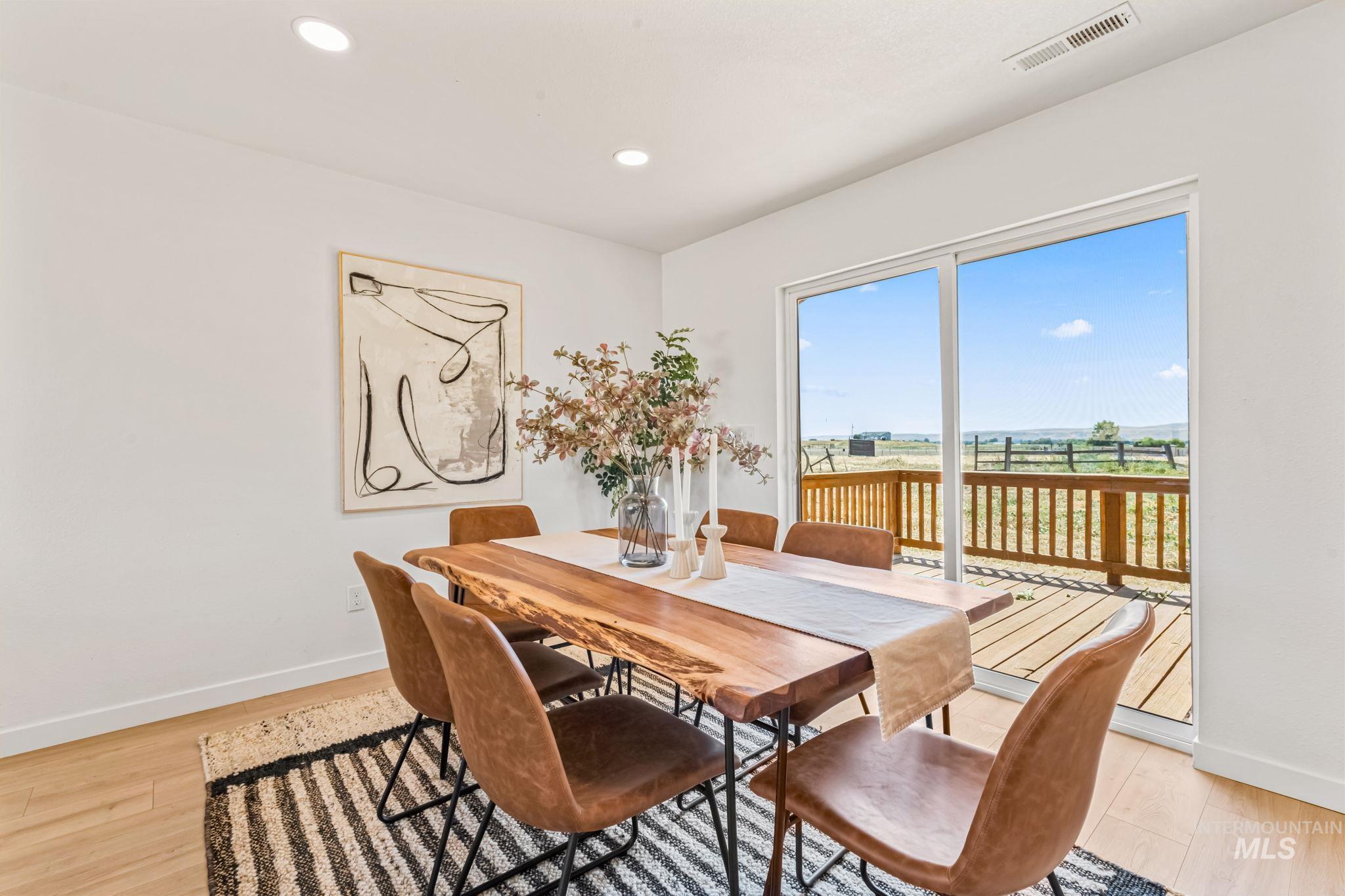 Dining space with light wood-style flooring and recessed lighting