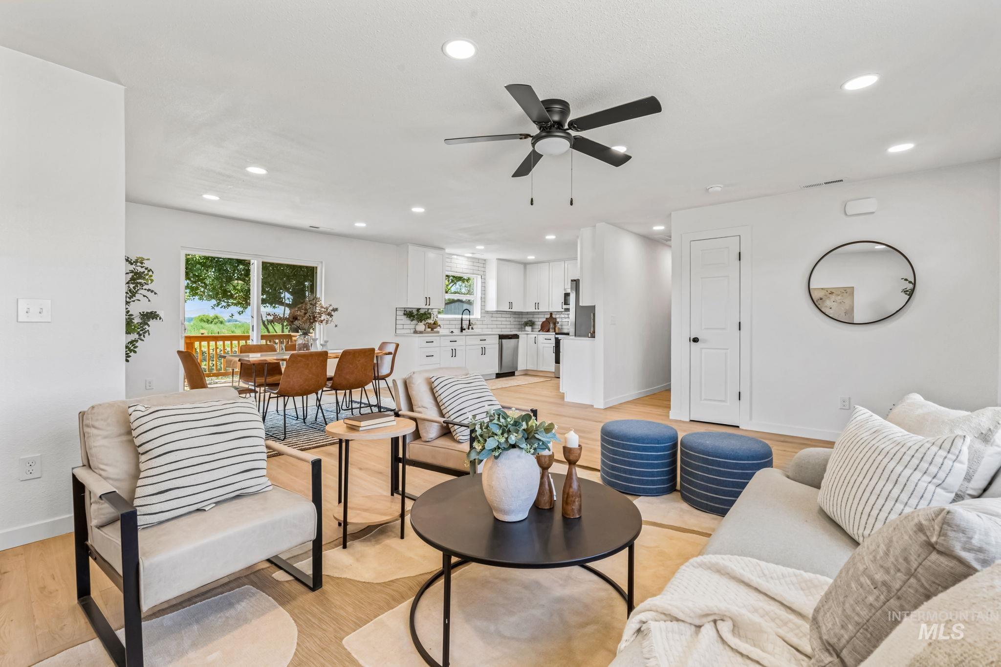Living room with light wood-type flooring, recessed lighting, and ceiling fan