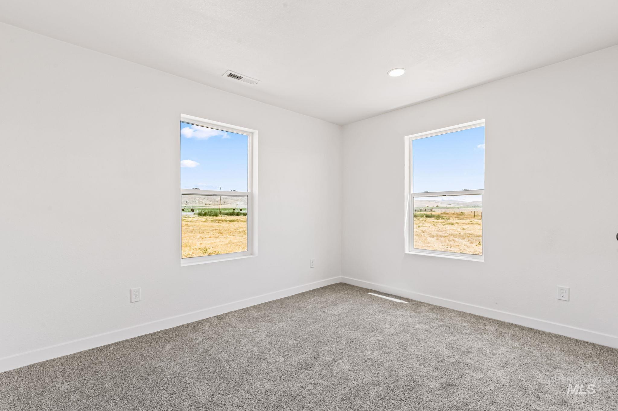Empty room featuring healthy amount of natural light, carpet, and recessed lighting