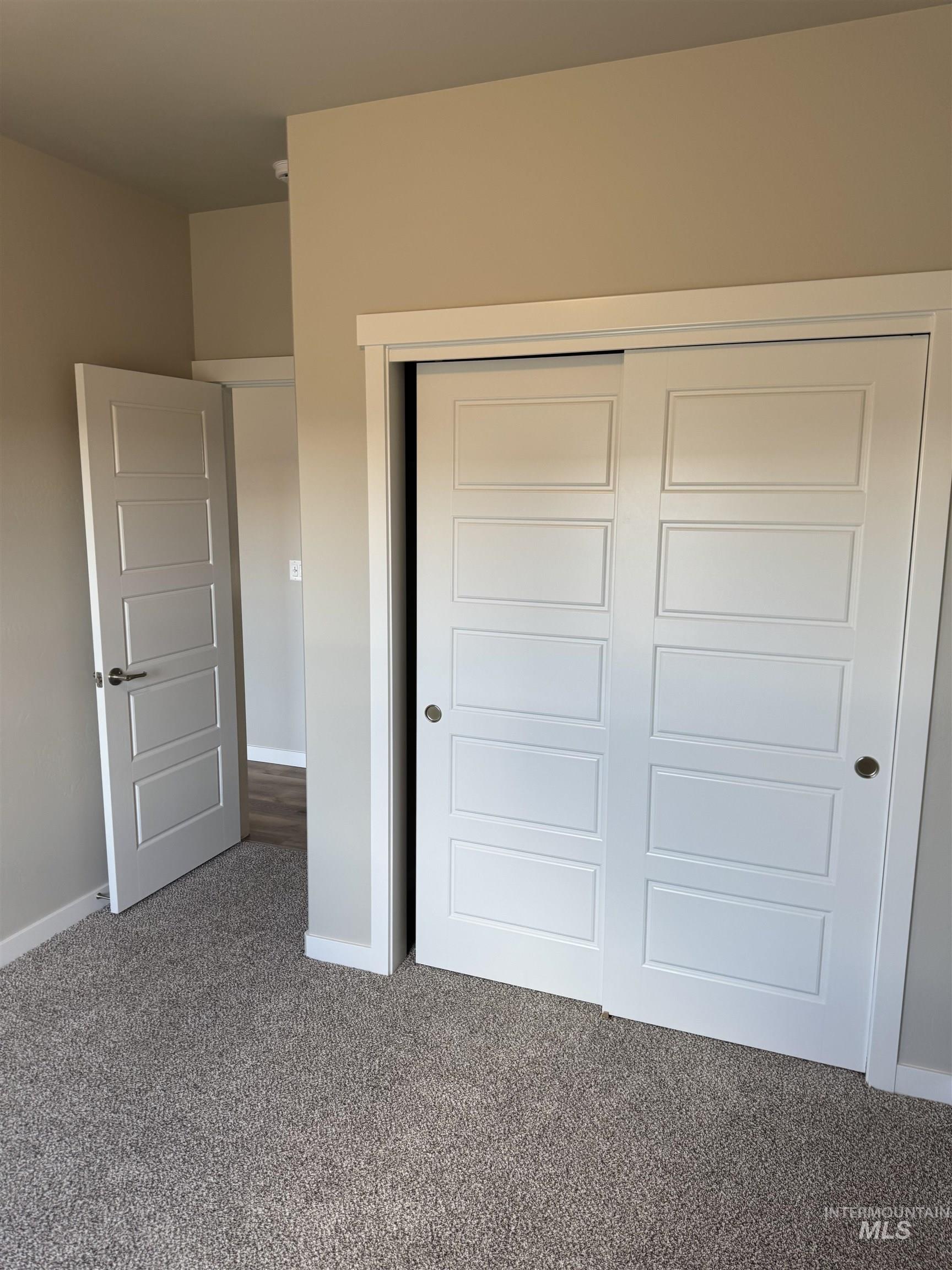 Unfurnished bedroom with carpet and a closet