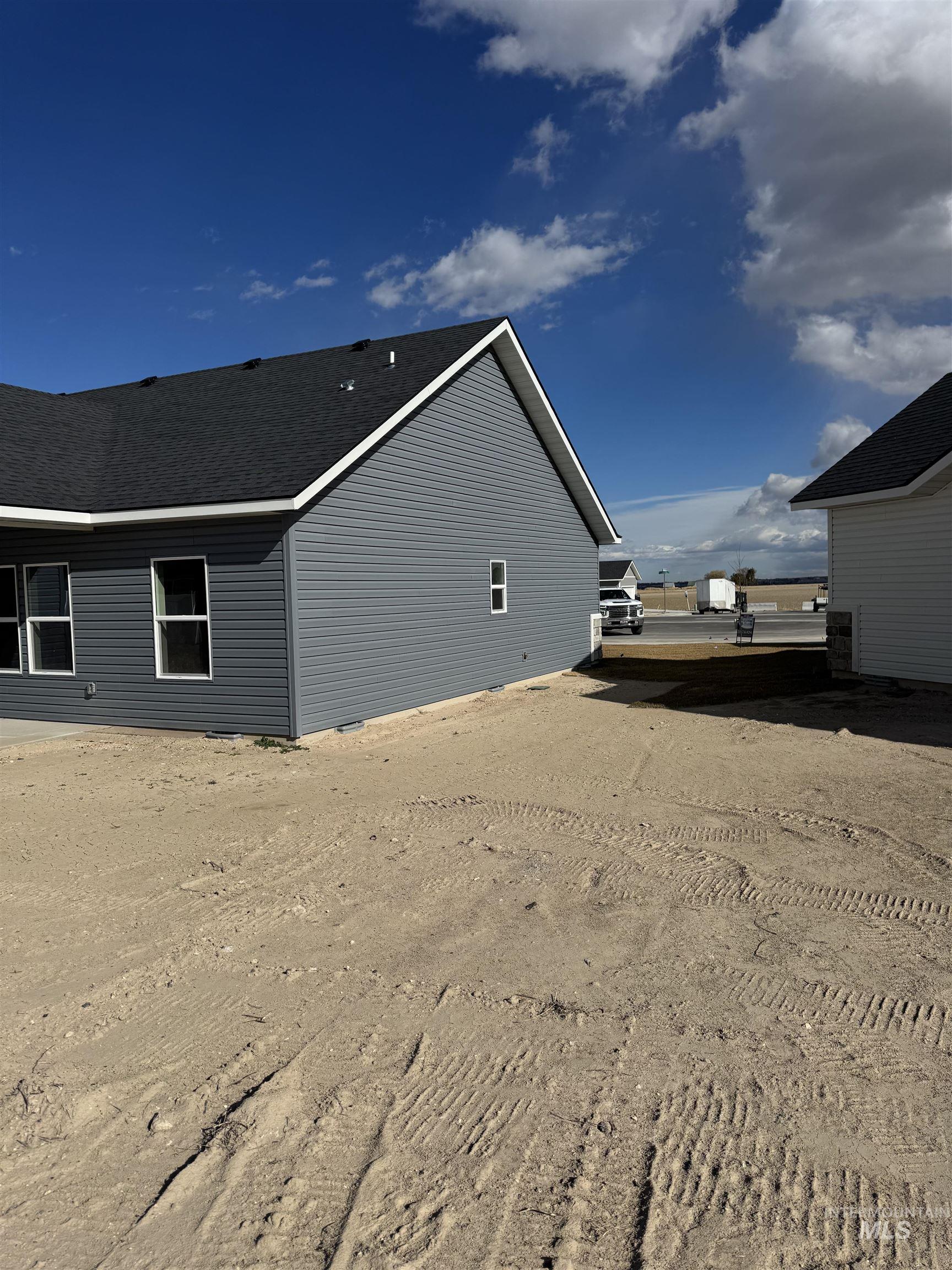 View of home's exterior featuring roof with shingles