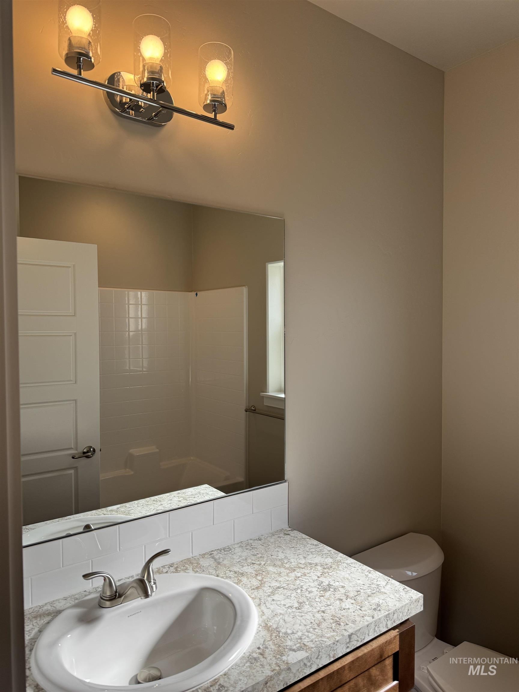 Full bathroom featuring vanity and washtub / shower combination