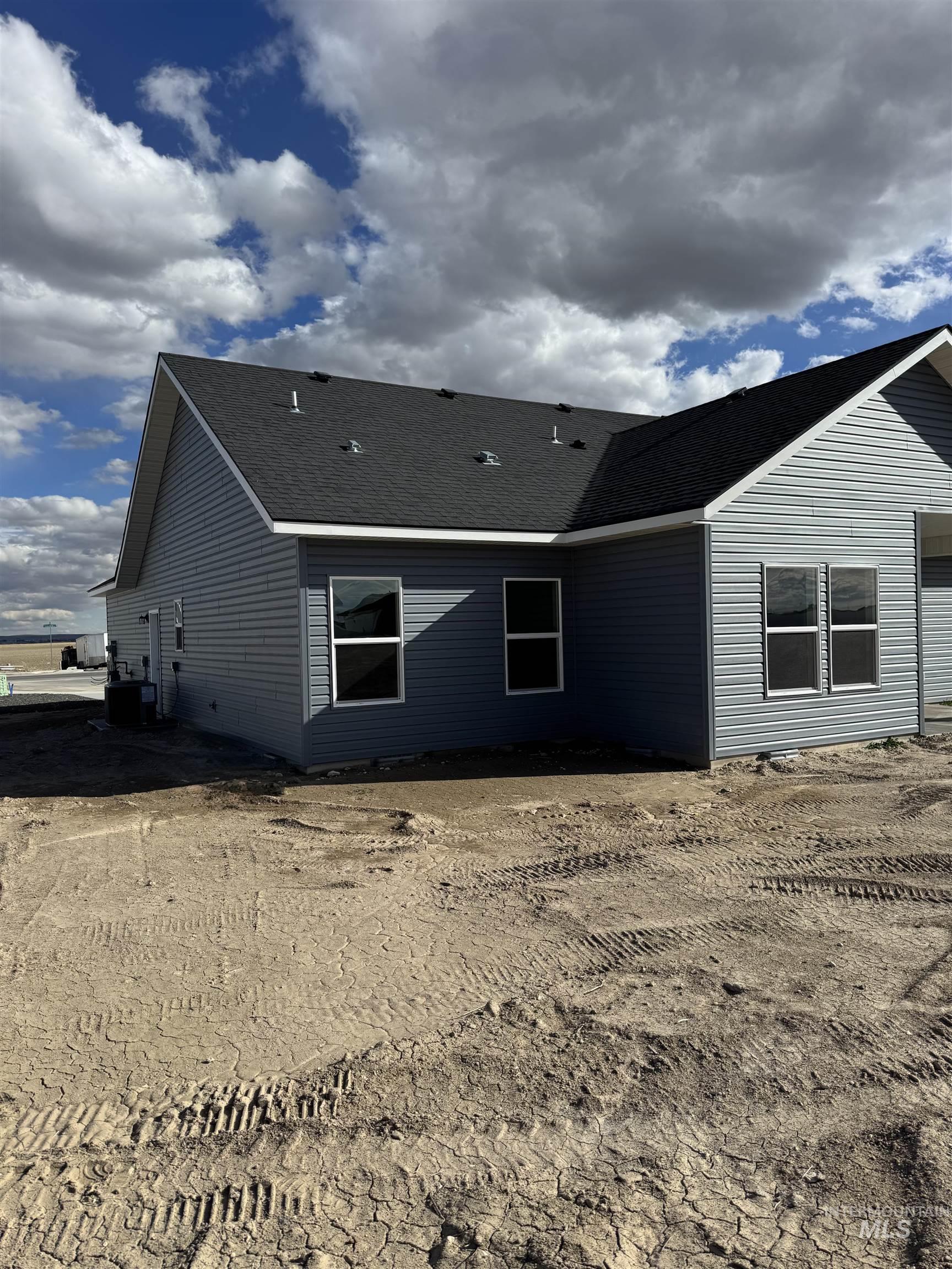 Rear view of house with roof with shingles