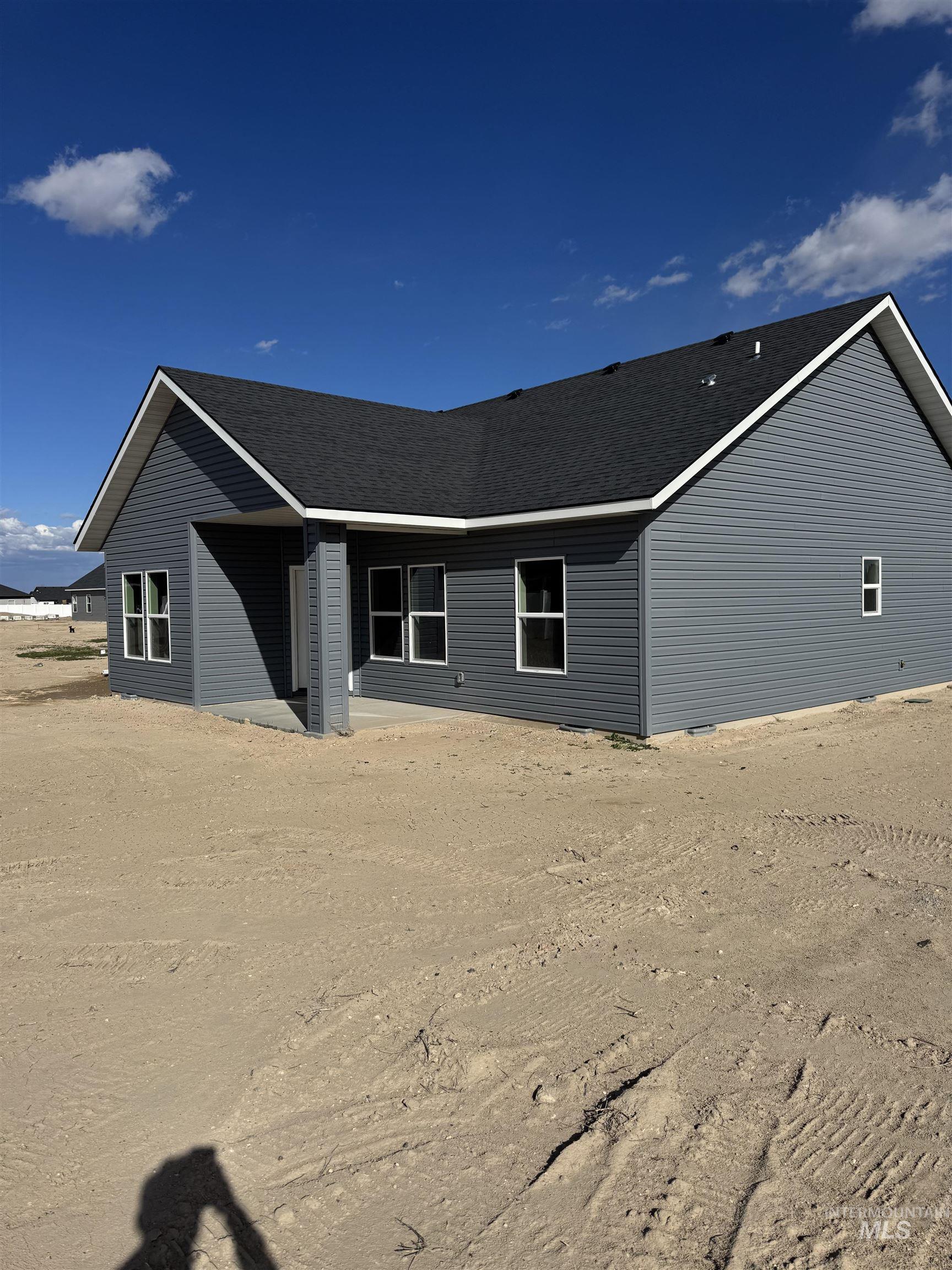 View of front of house with a shingled roof