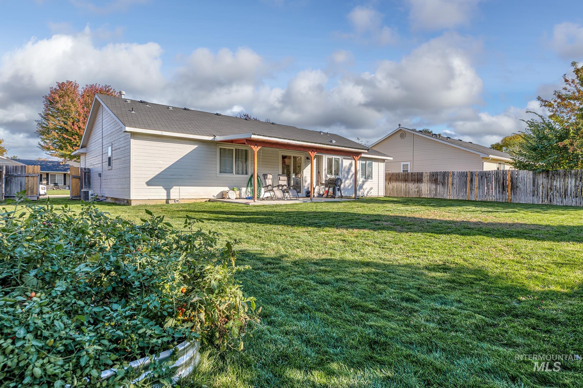 Rear view of property with a patio area and a fenced backyard