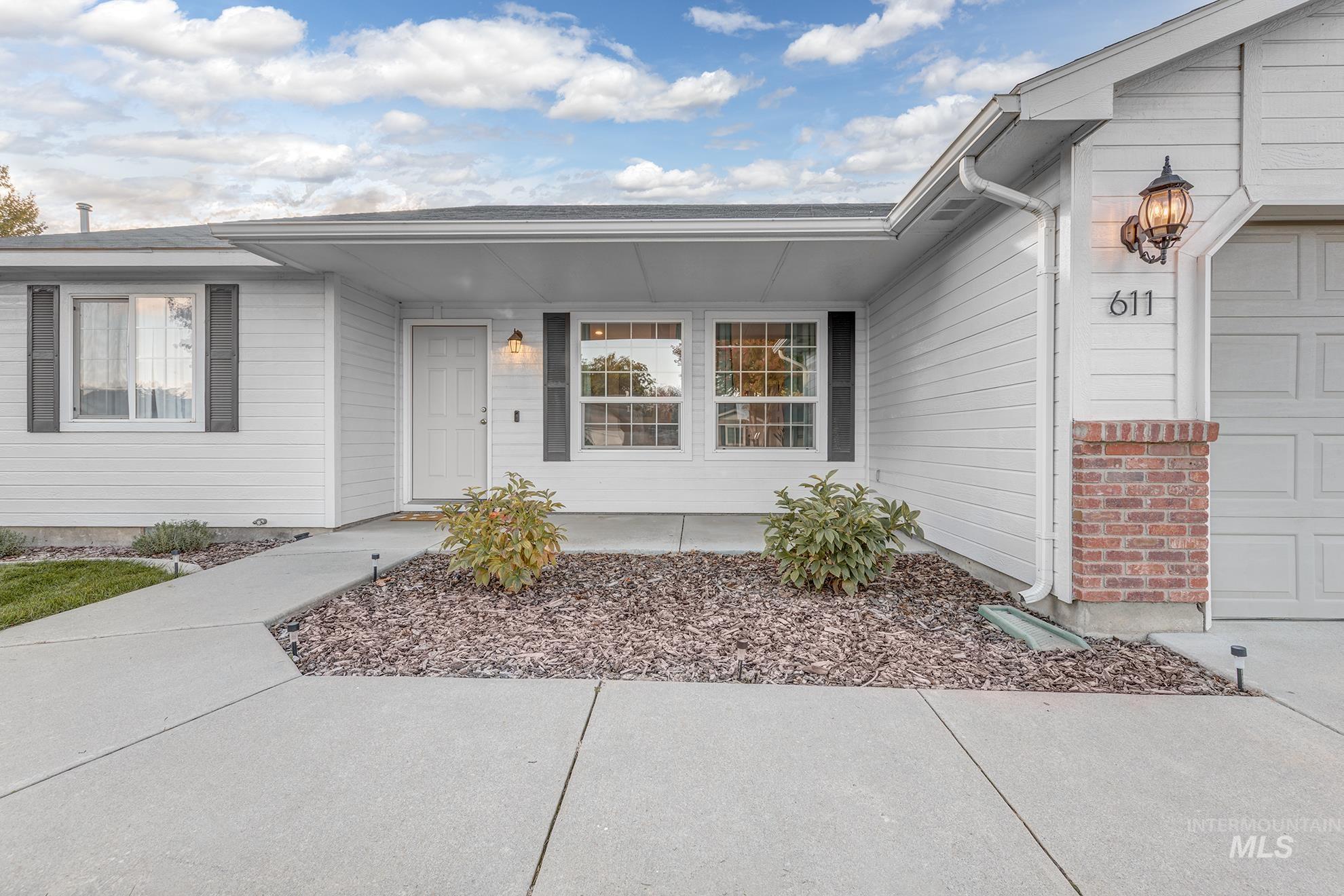 Property entrance featuring an attached garage and a porch
