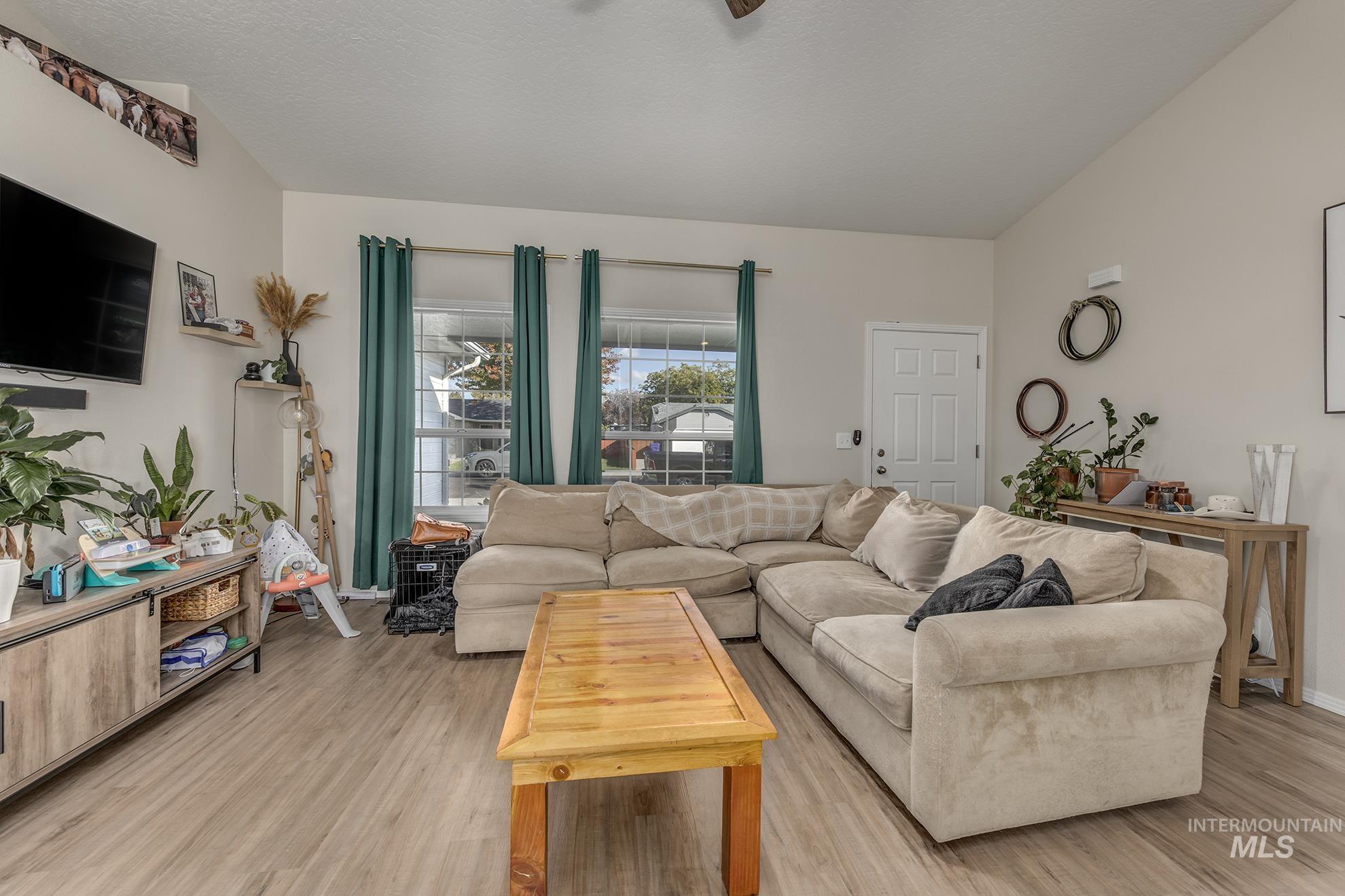 Living room featuring light wood-style floors and ceiling fan