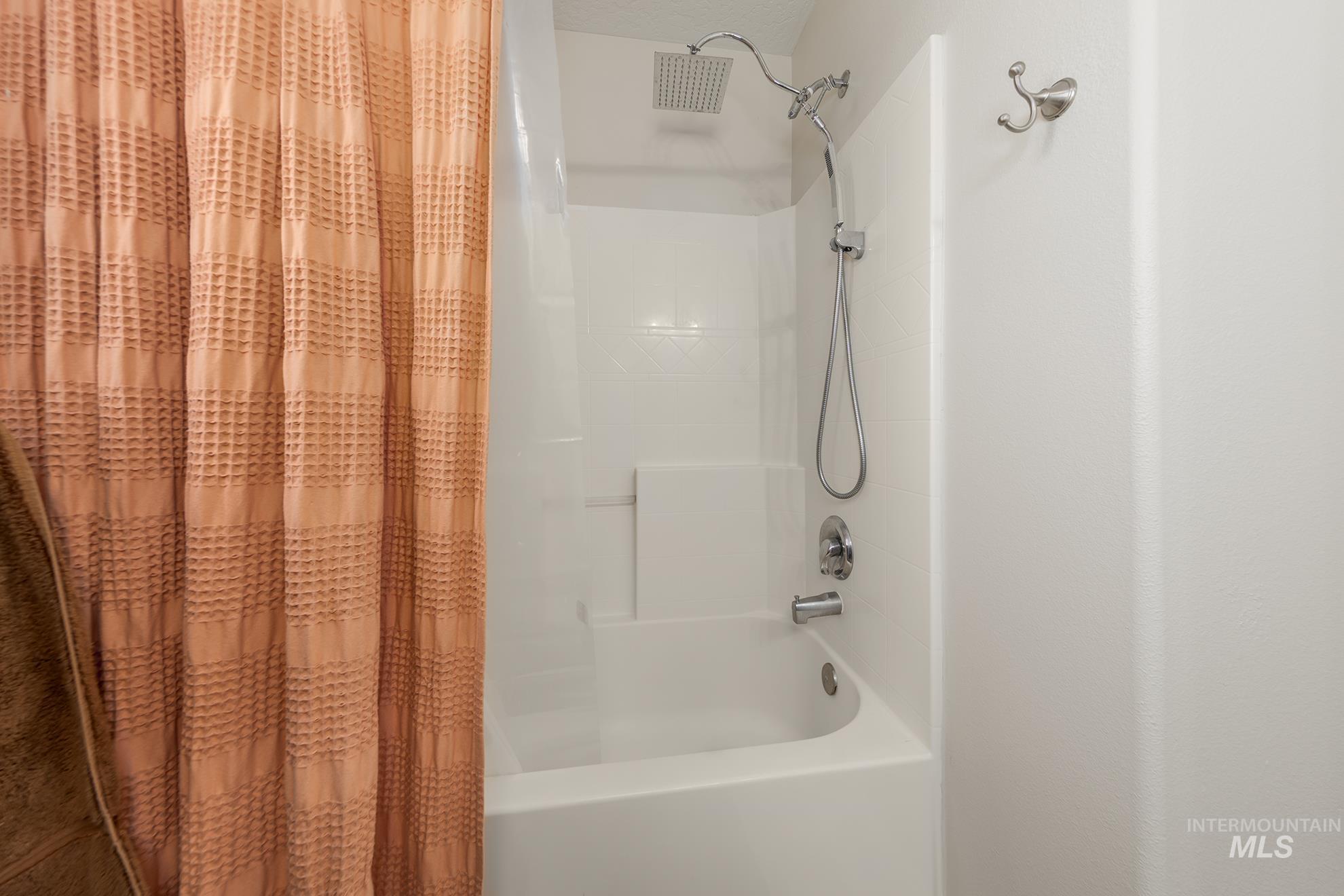 Bathroom featuring shower / tub combo with curtain