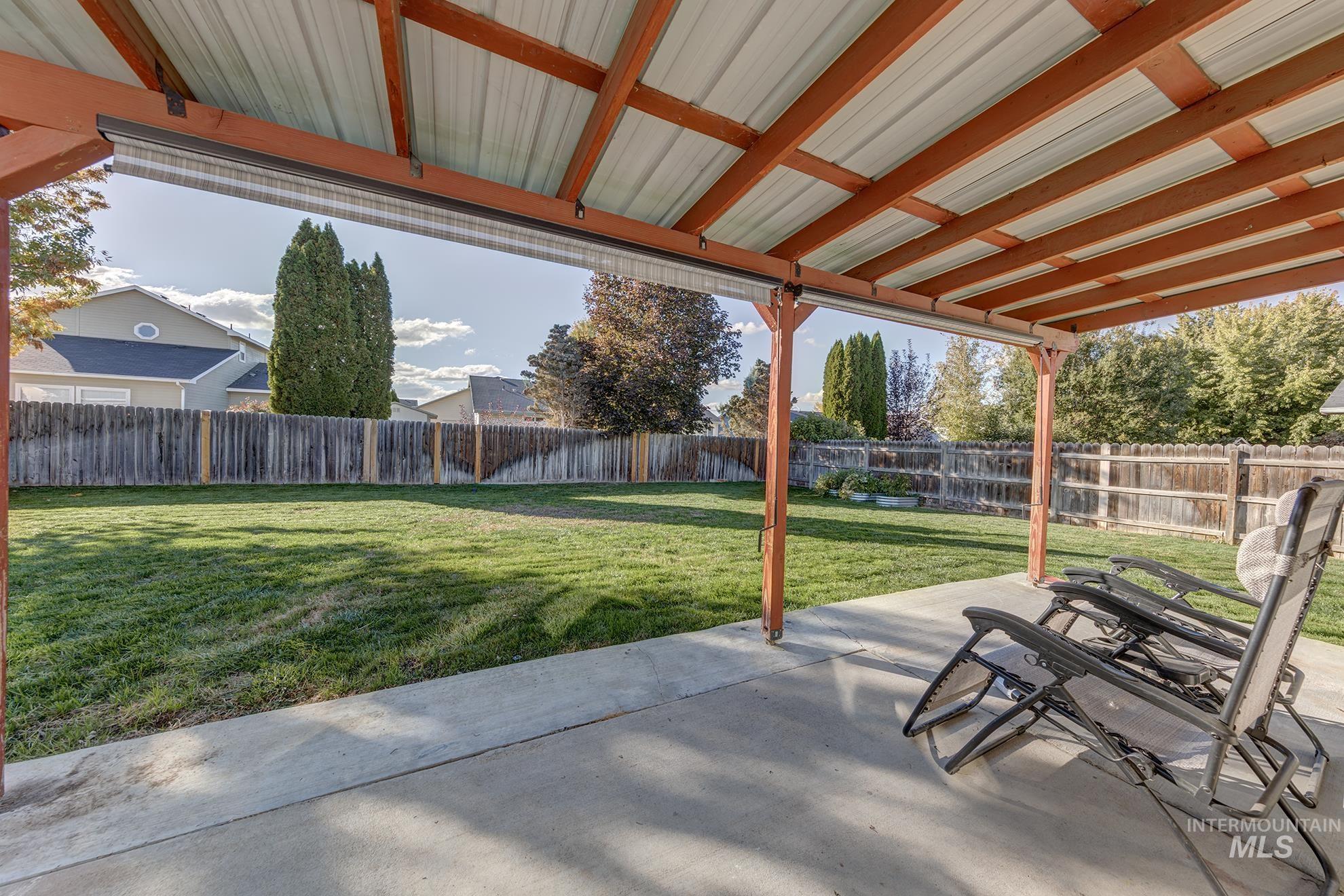 Fenced backyard featuring a patio