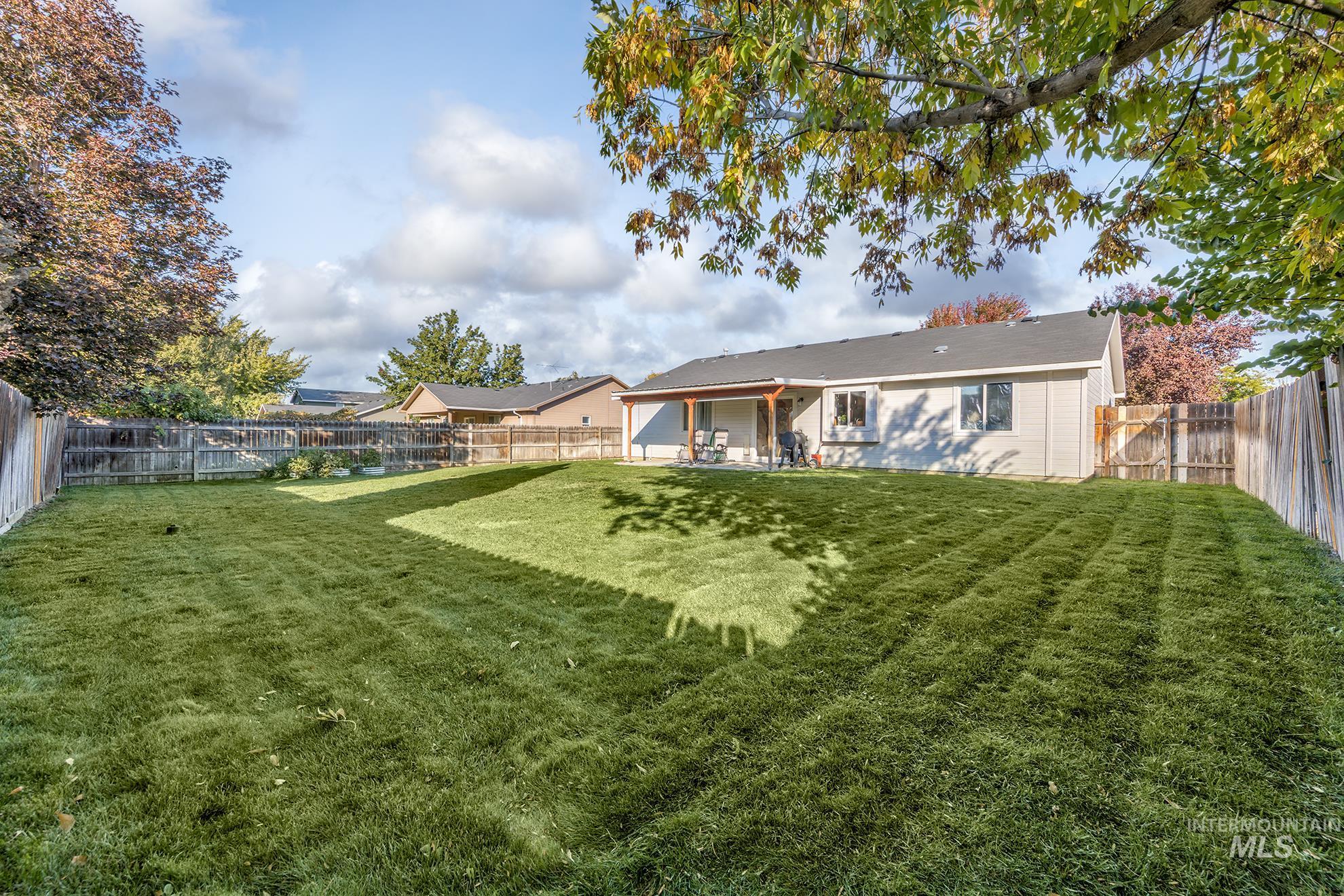 Rear view of house featuring a patio and a fenced backyard