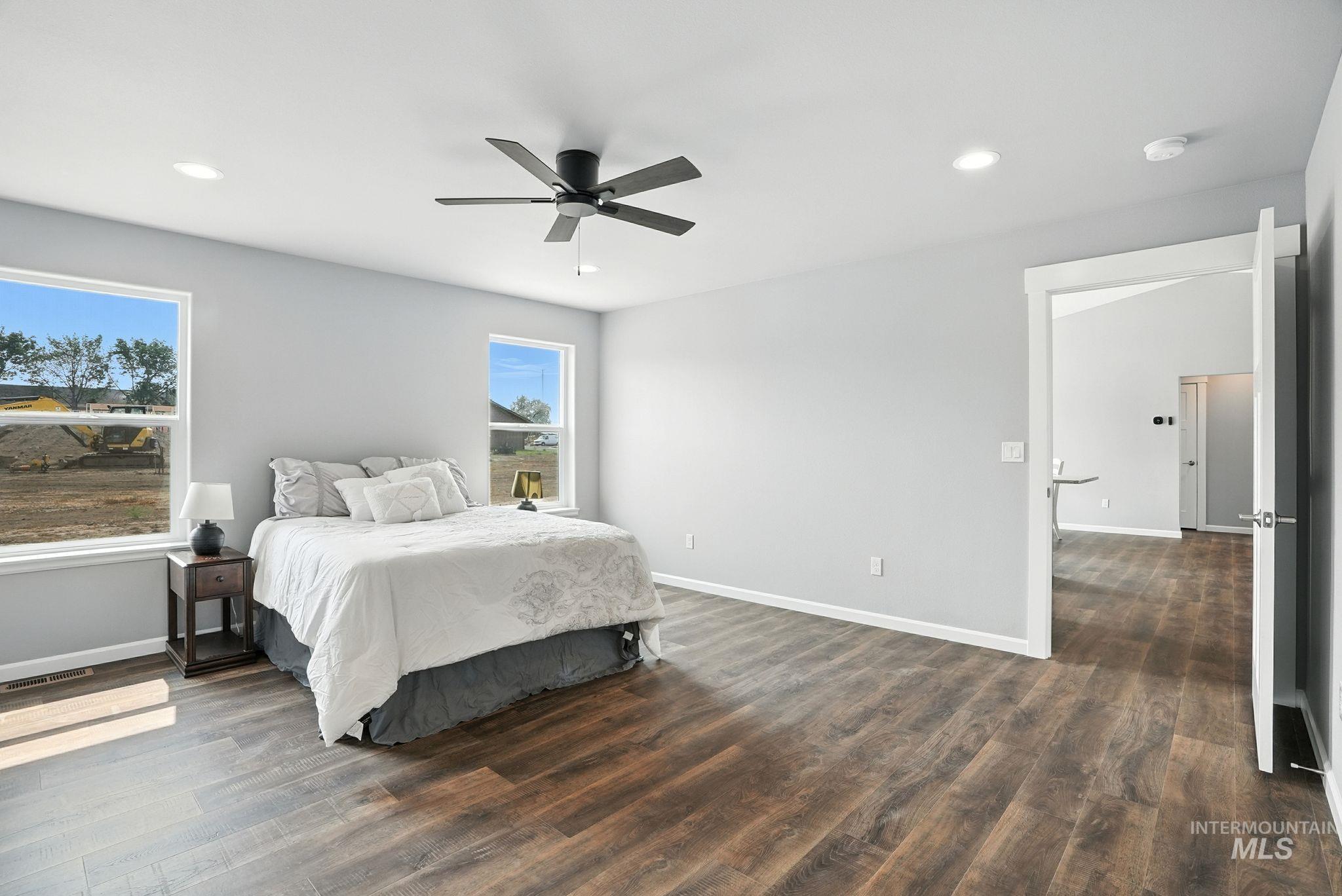 Bedroom with dark wood-style flooring, recessed lighting, and a ceiling fan