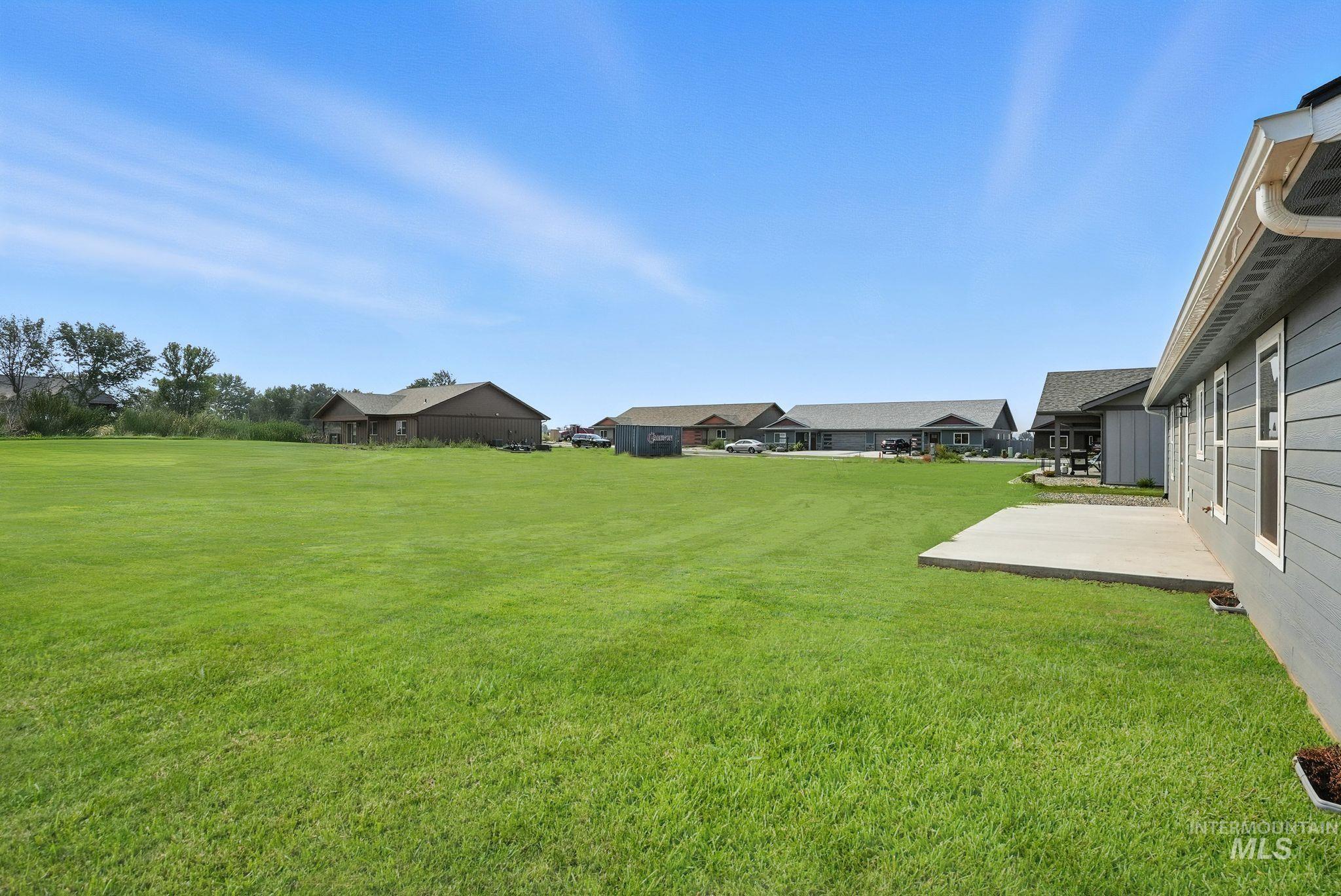 View of green lawn featuring a patio area