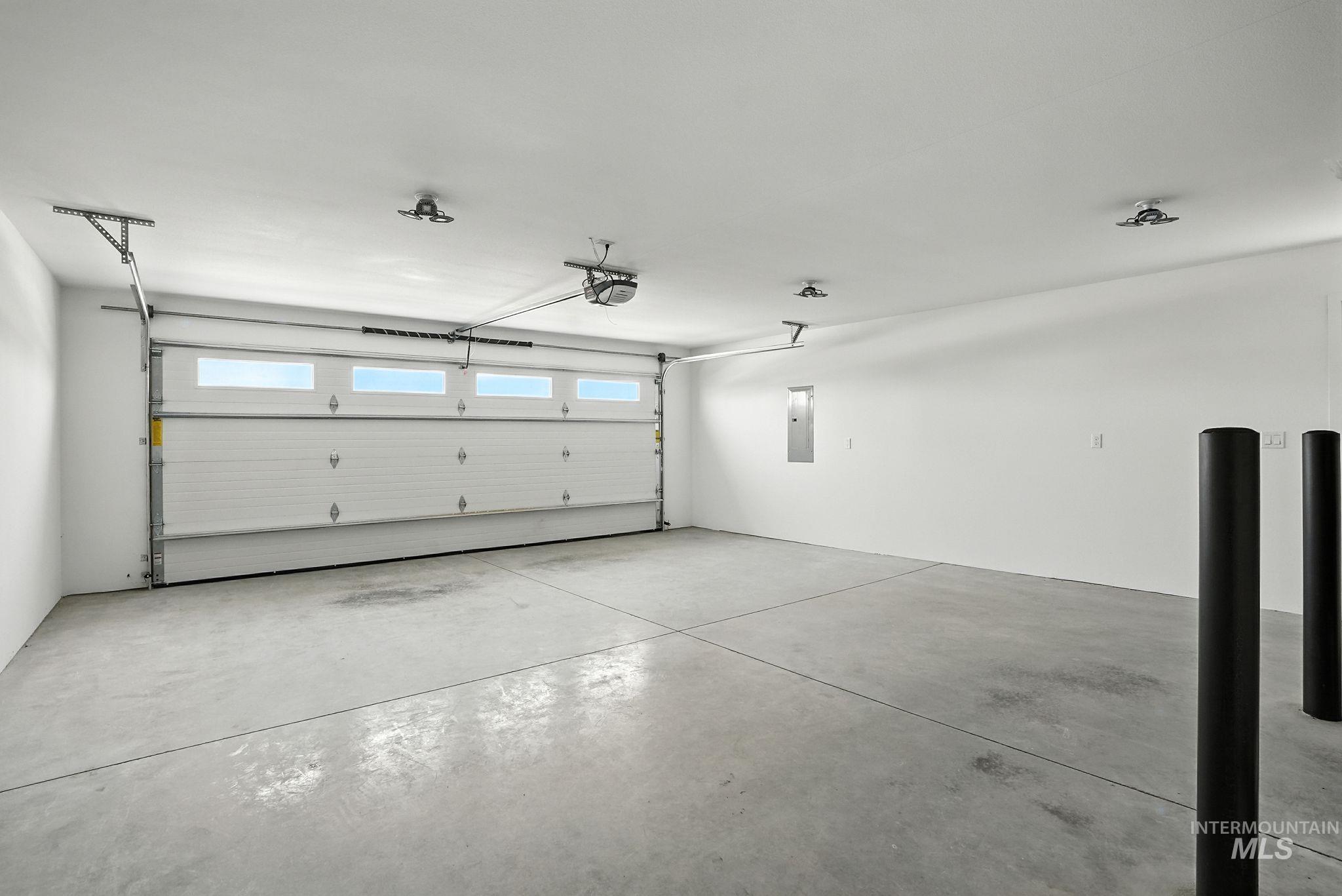 Garage with electric panel and a garage door opener
