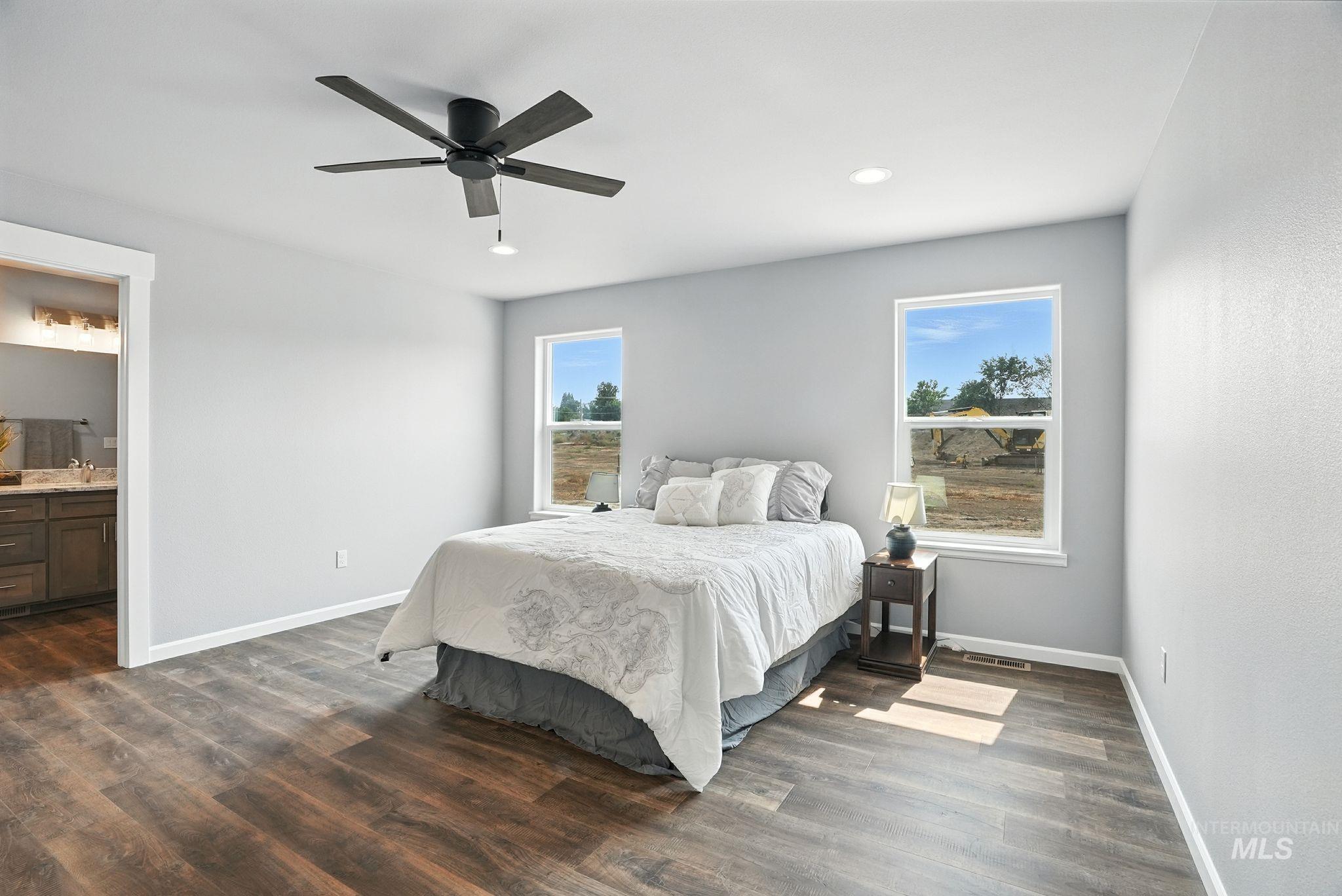 Bedroom with ensuite bathroom, dark wood-style floors, a ceiling fan, and recessed lighting