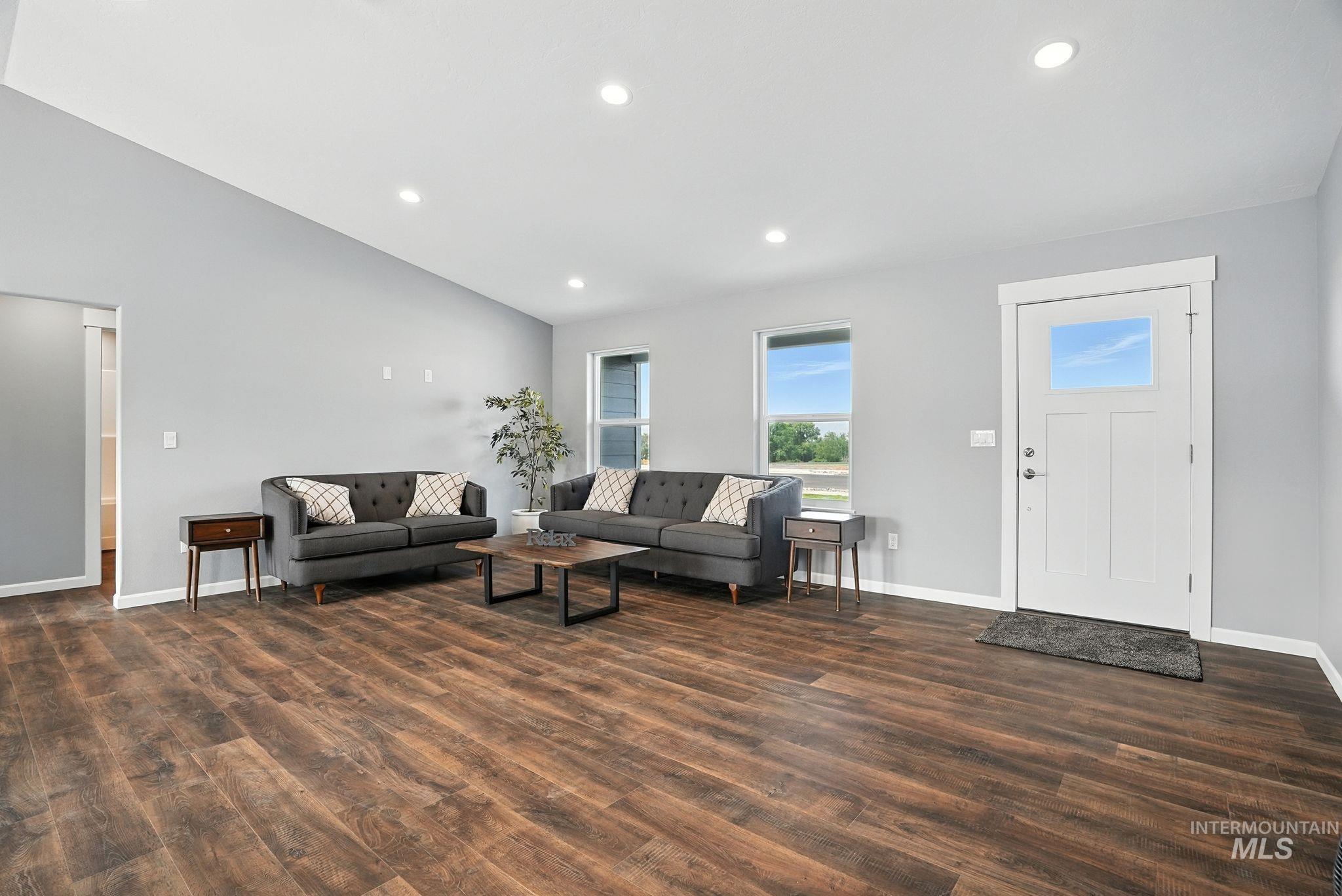 Living area with recessed lighting and dark wood finished floors