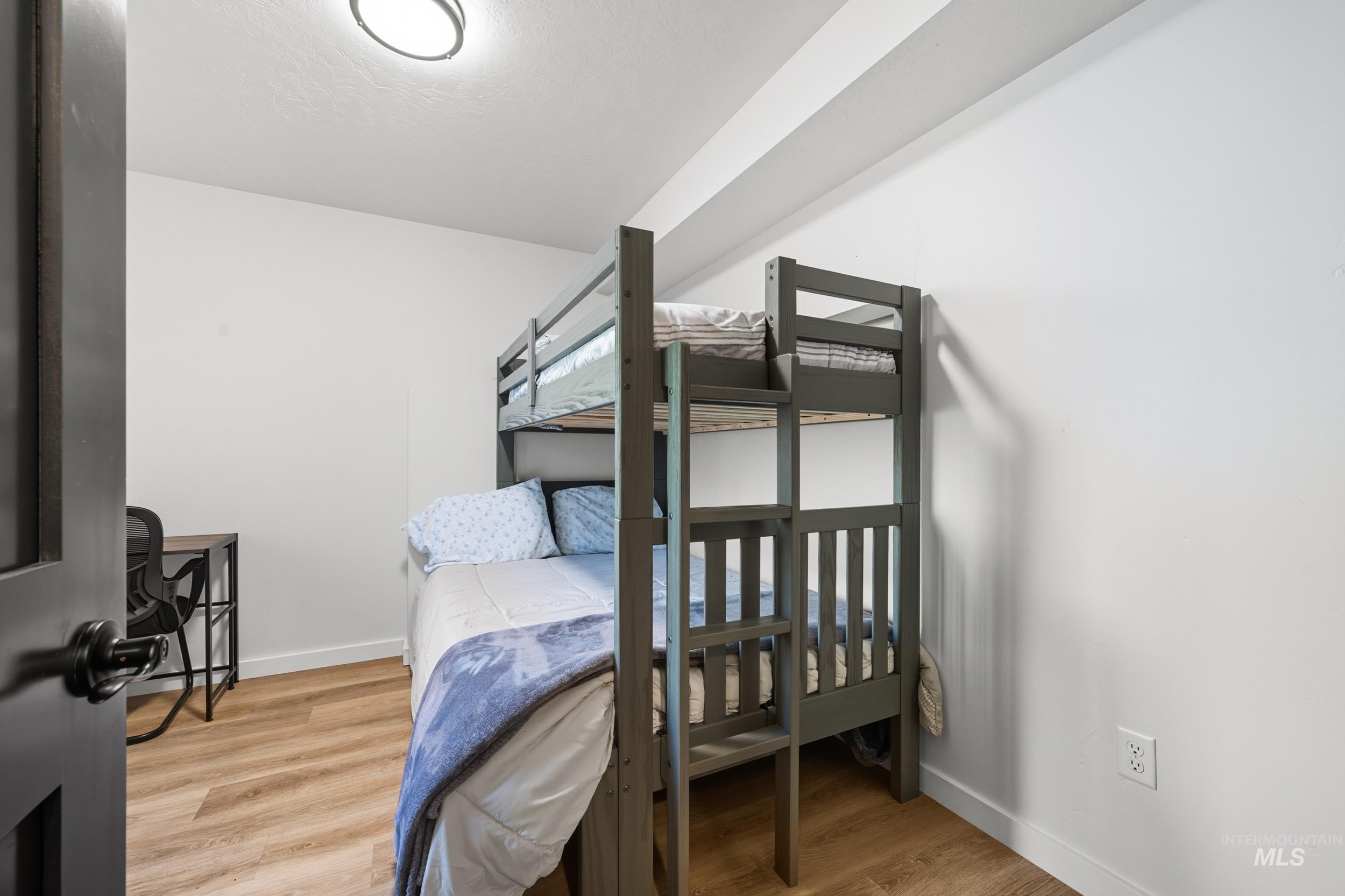 Bedroom with baseboards and light wood-style flooring
