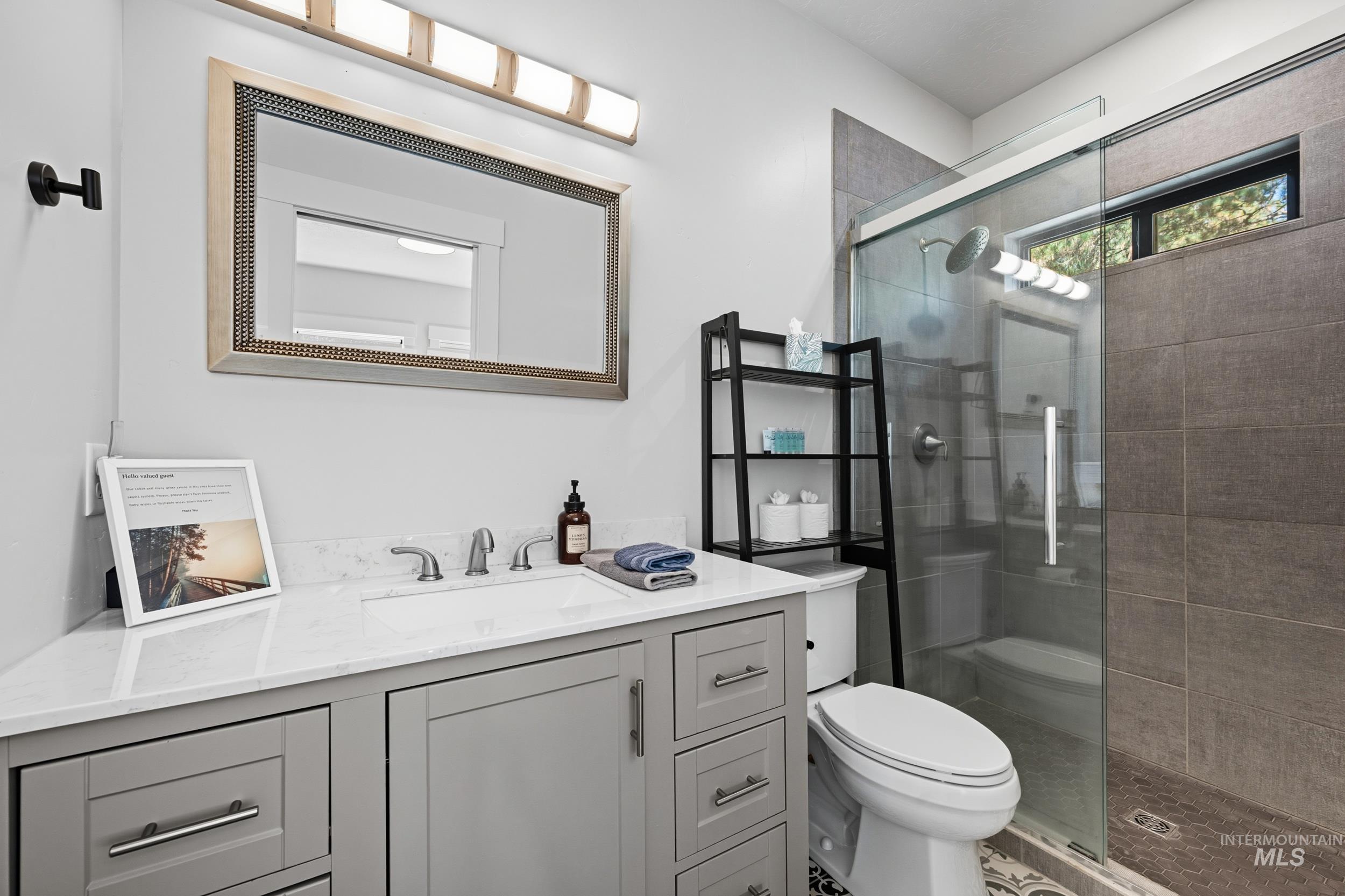 Full bathroom with a shower stall and vanity