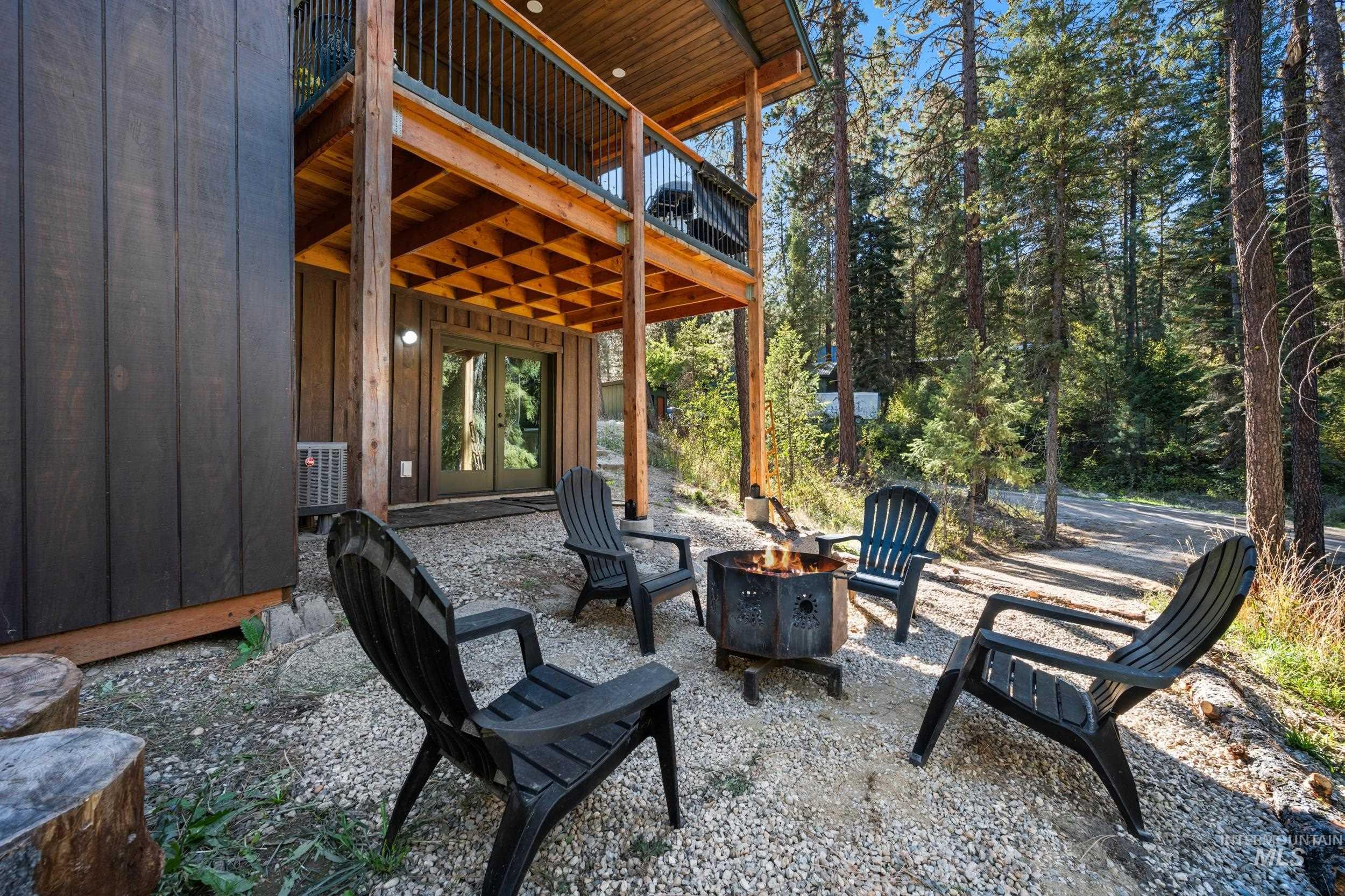 View of patio with an outdoor fire pit
