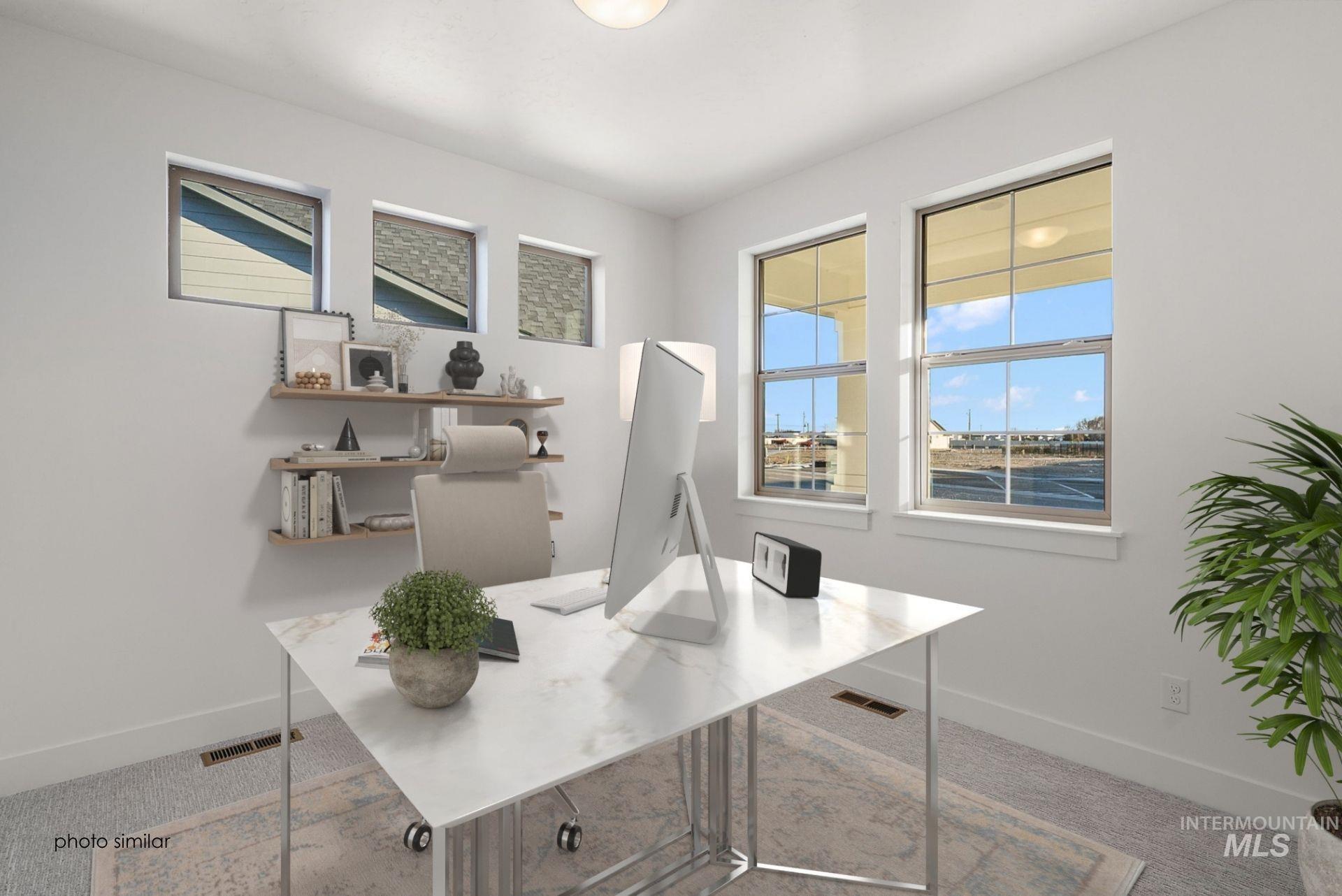 Office space featuring baseboards and light carpet