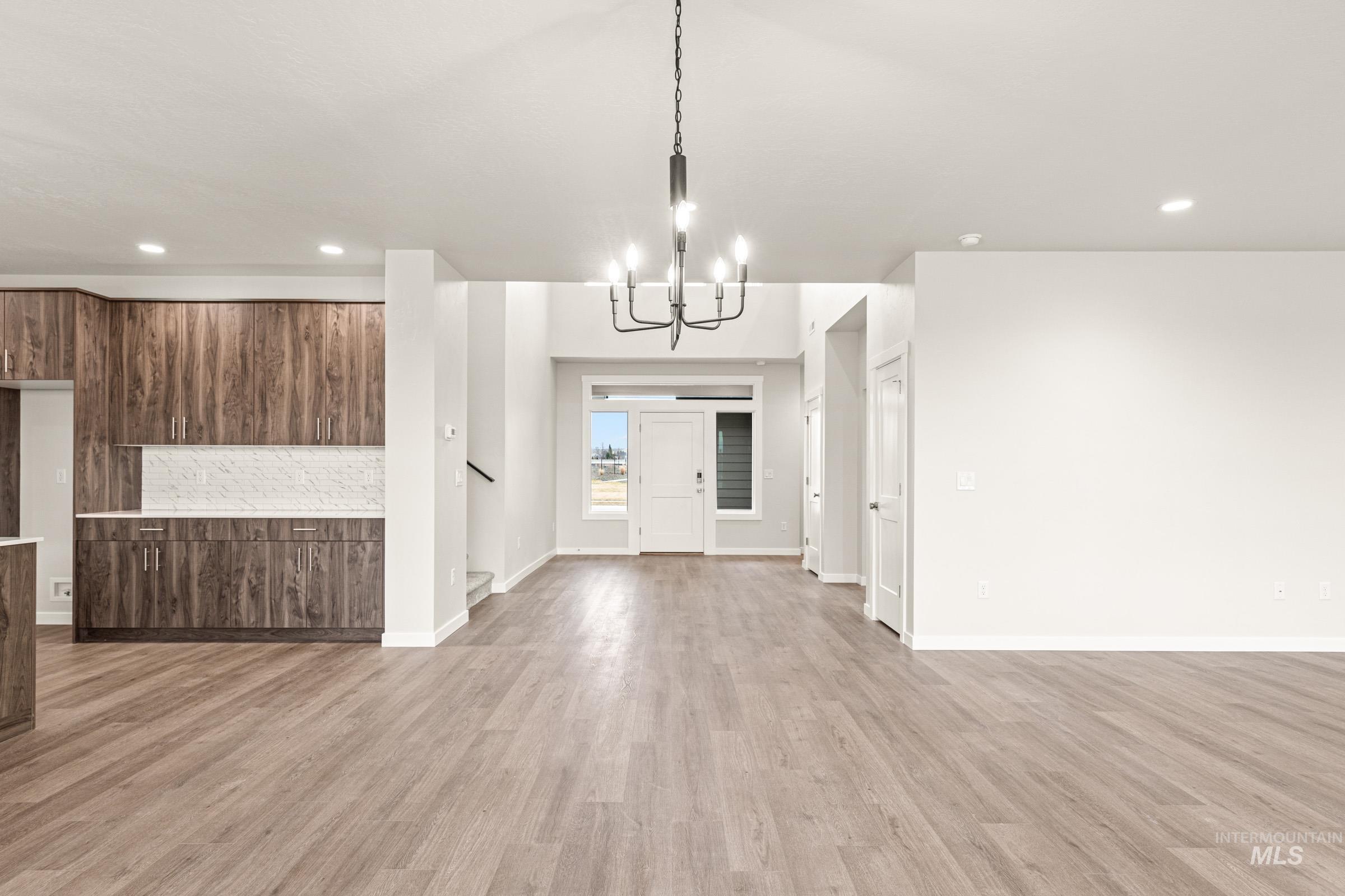 Open-concept main living area with wood-finish flooring
