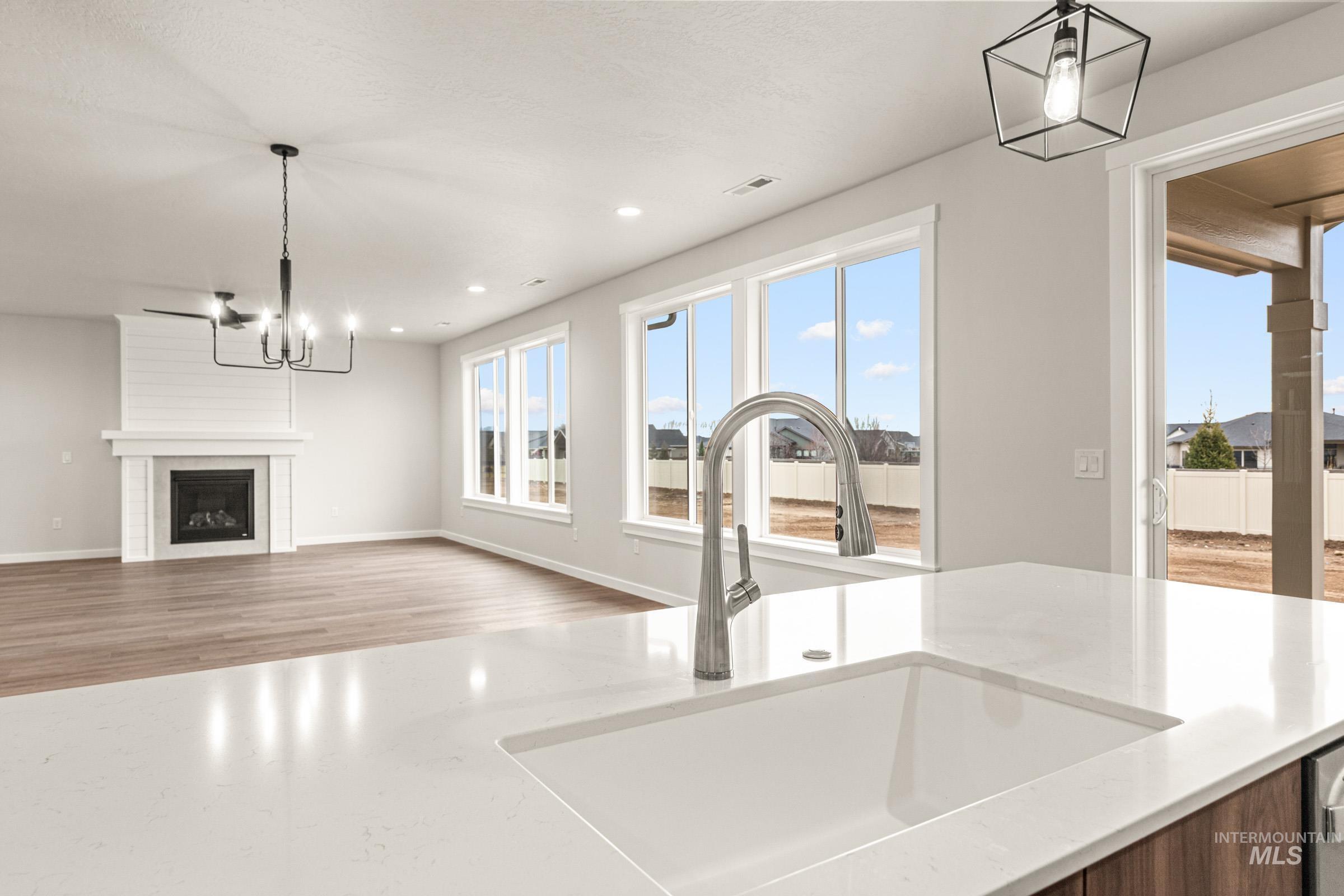 Spacious kitchen island featuring an integrated sink with a chrome faucet, complemented by wood-finish cabinetry