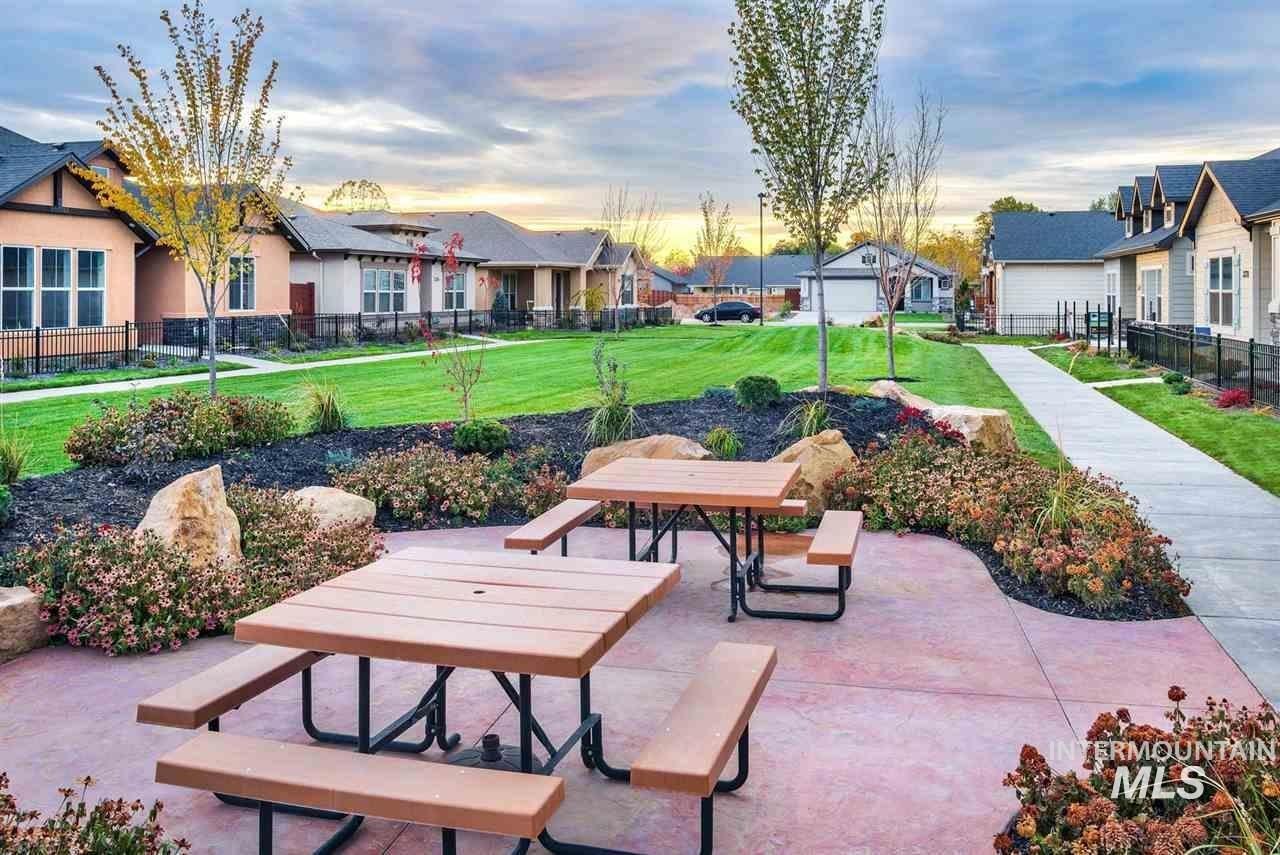 Community picnic area featuring two picnic tables on a concrete patio