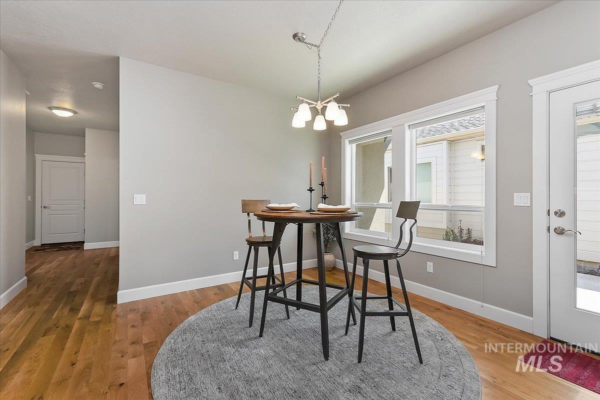 Wood-finish flooring throughout, complemented by light gray wall paint and white trim