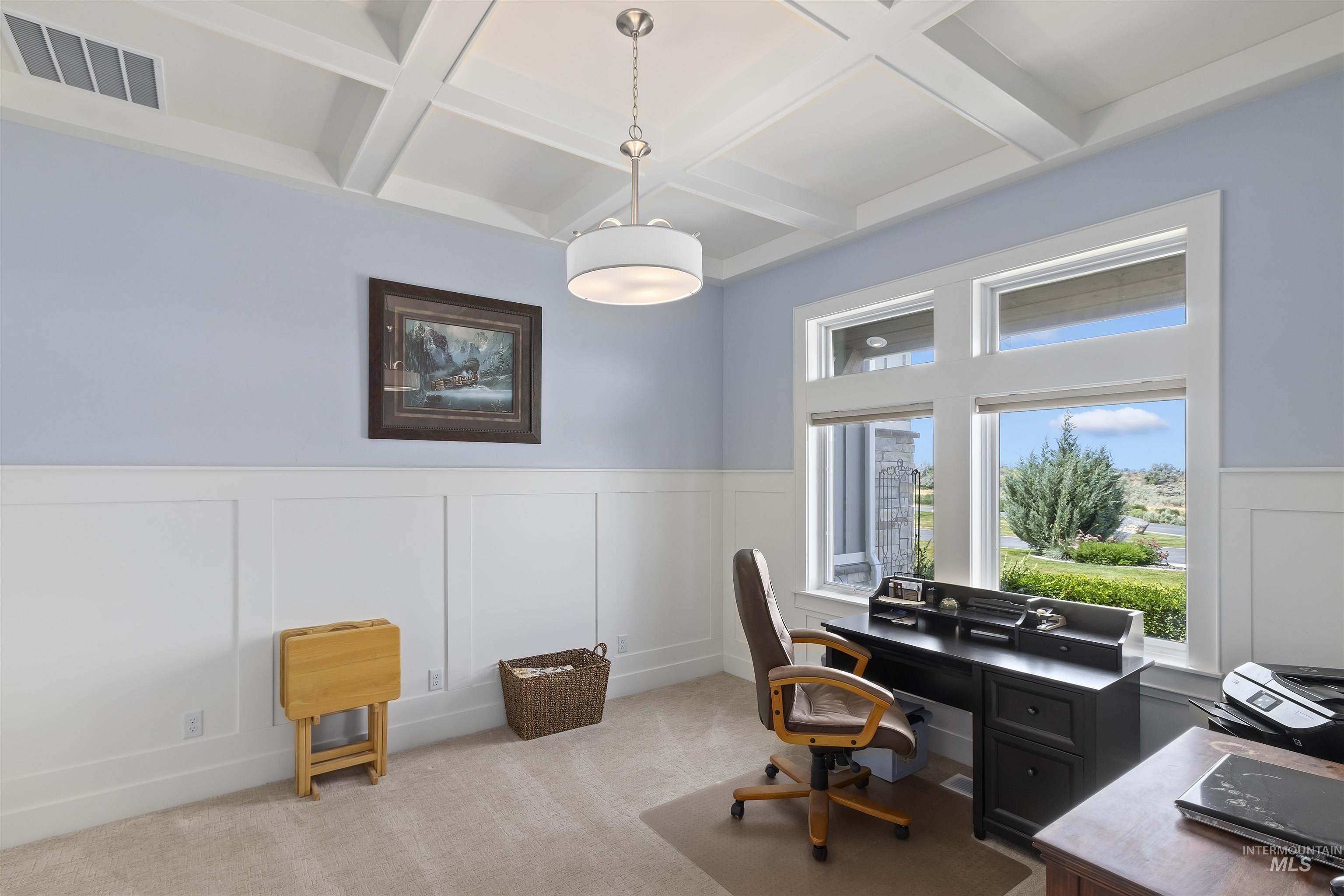 Office area with coffered ceiling, wainscoting, a decorative wall, beamed ceiling, and light colored carpet