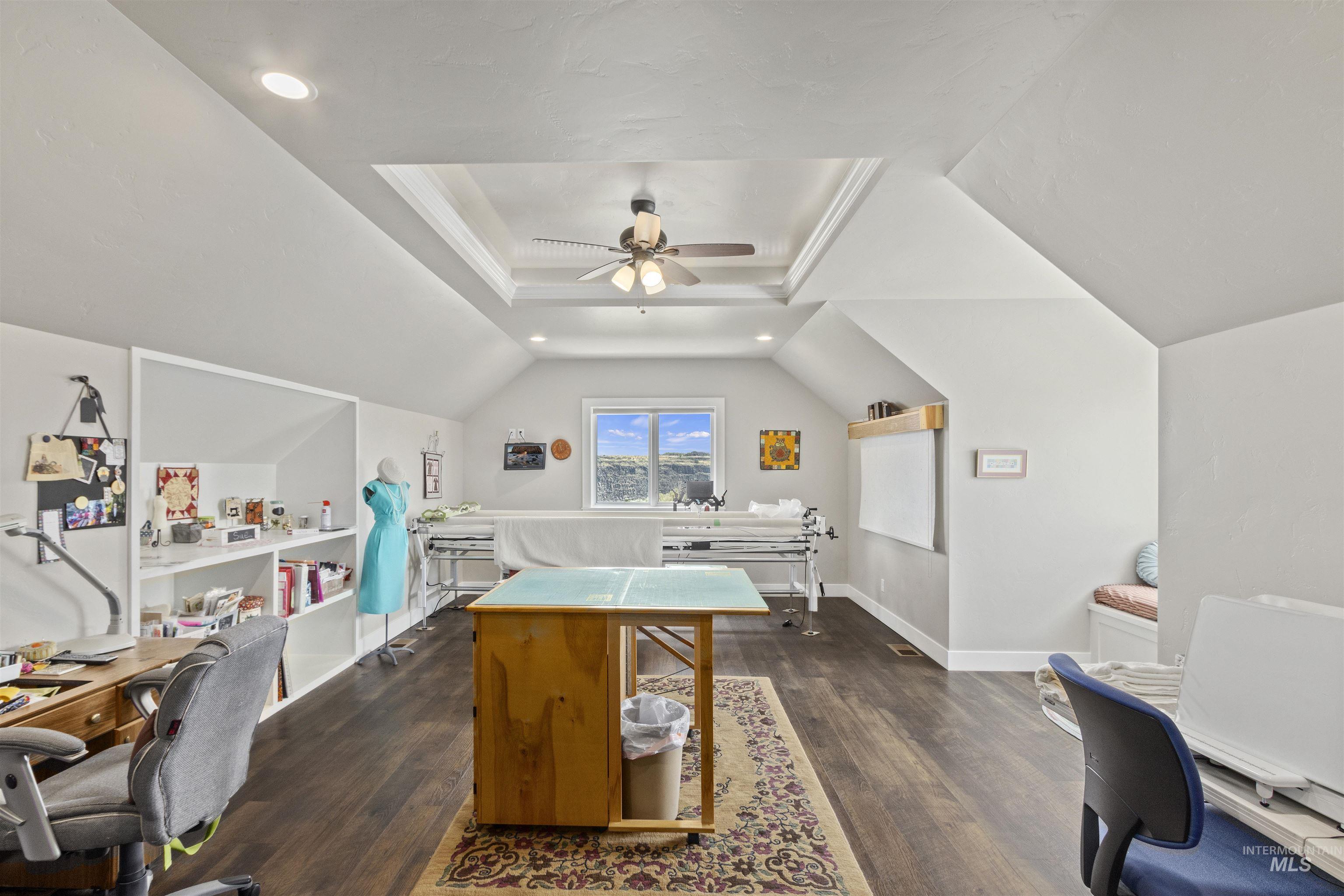 Office space featuring dark wood-type flooring, lofted ceiling, a ceiling fan, and recessed lighting
