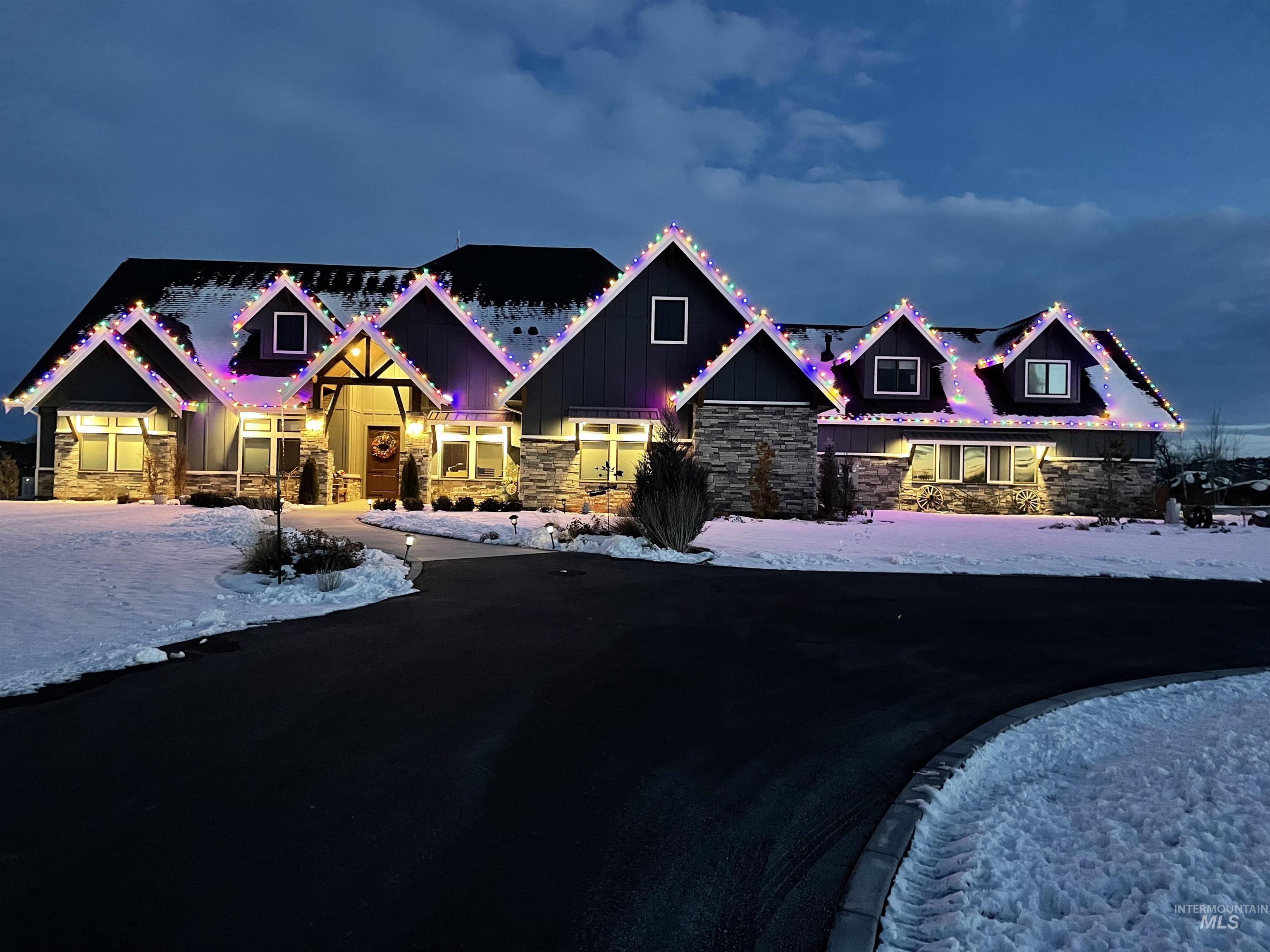 Craftsman inspired home featuring stone siding and board and batten siding