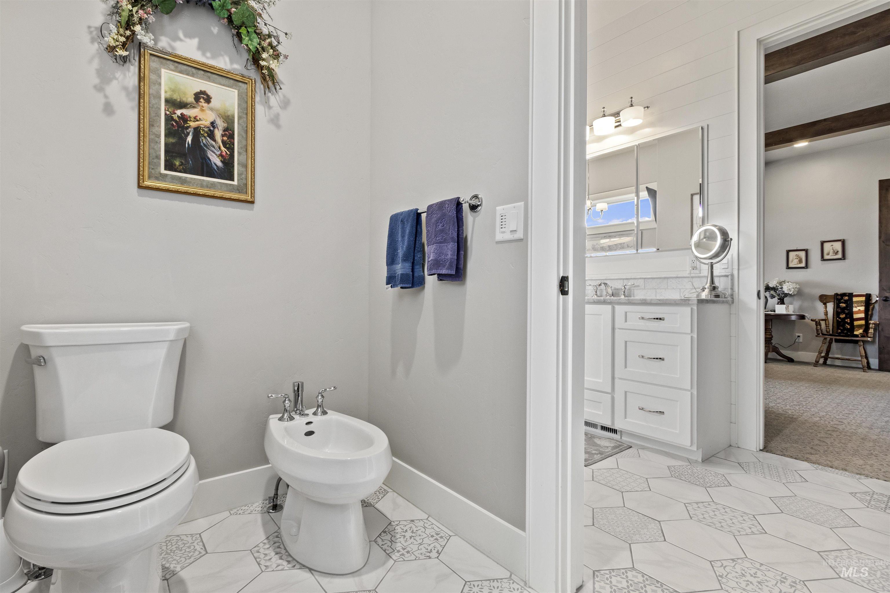 Bathroom featuring a bidet, vanity, and tile patterned floors