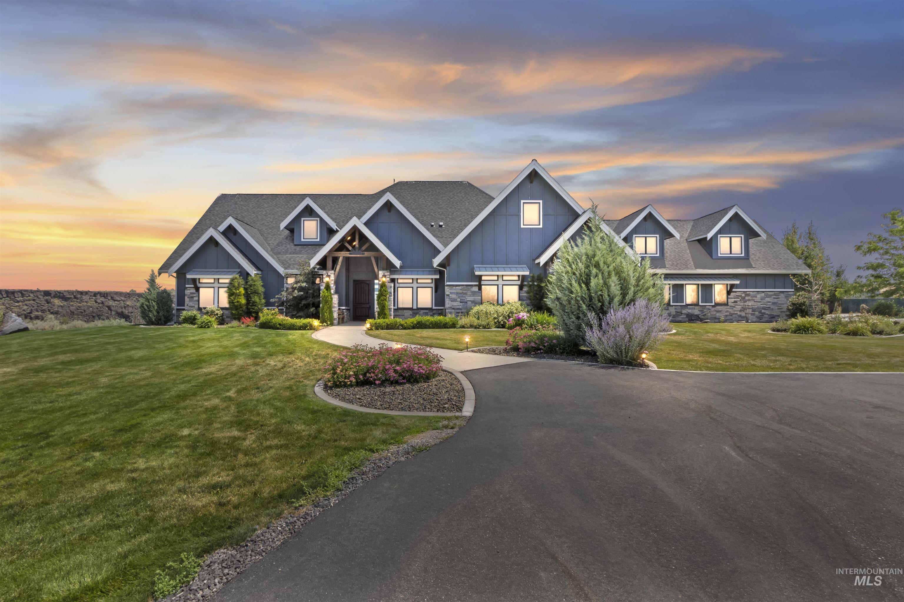 Craftsman house featuring board and batten siding, stone siding, and a front lawn