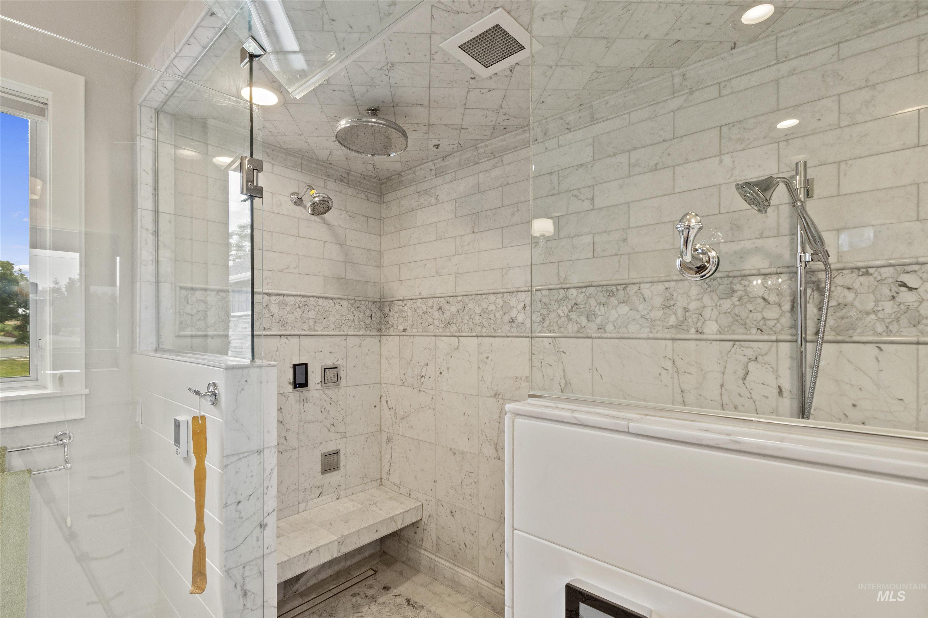 Full bathroom featuring tiled shower and recessed lighting