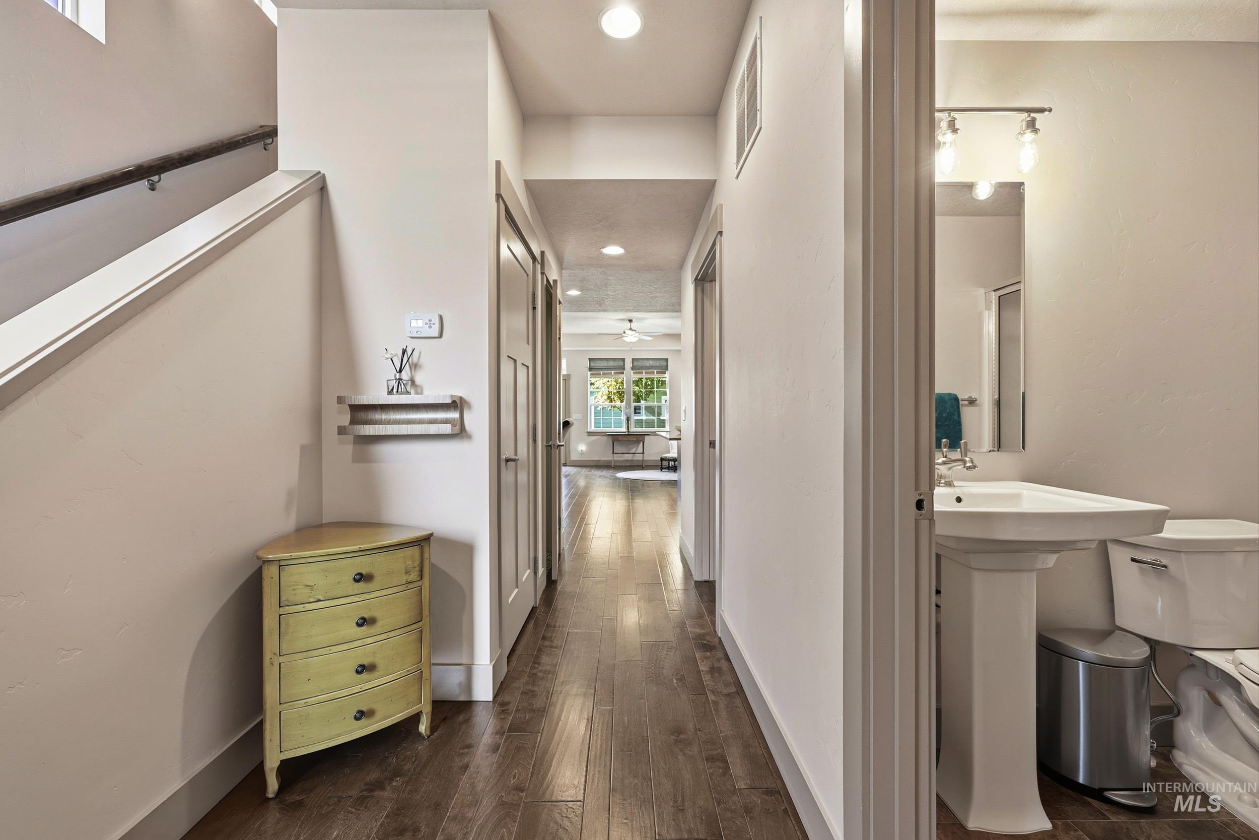 Hallway with recessed lighting and dark wood-type flooring