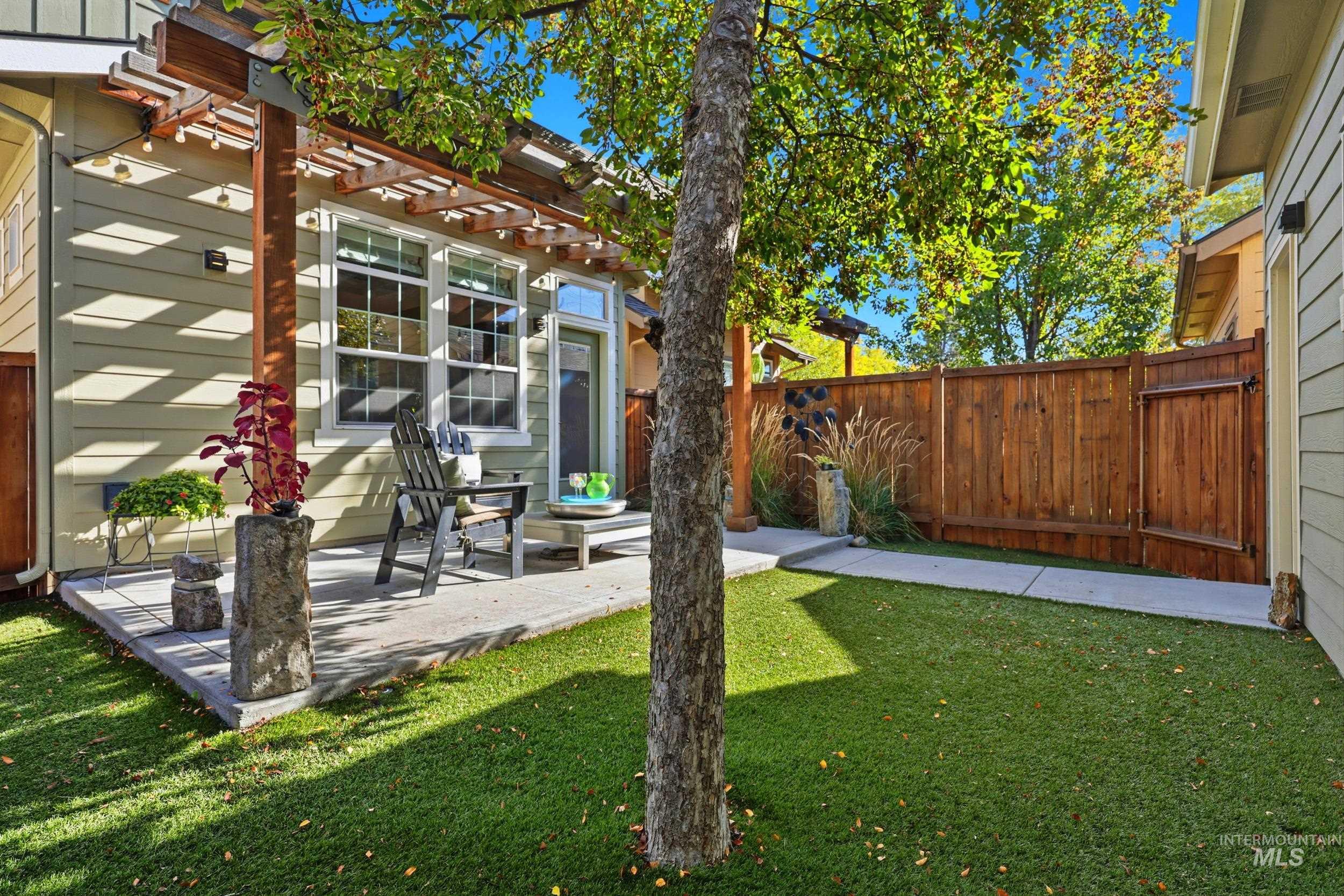 Fenced backyard with a patio and a pergola