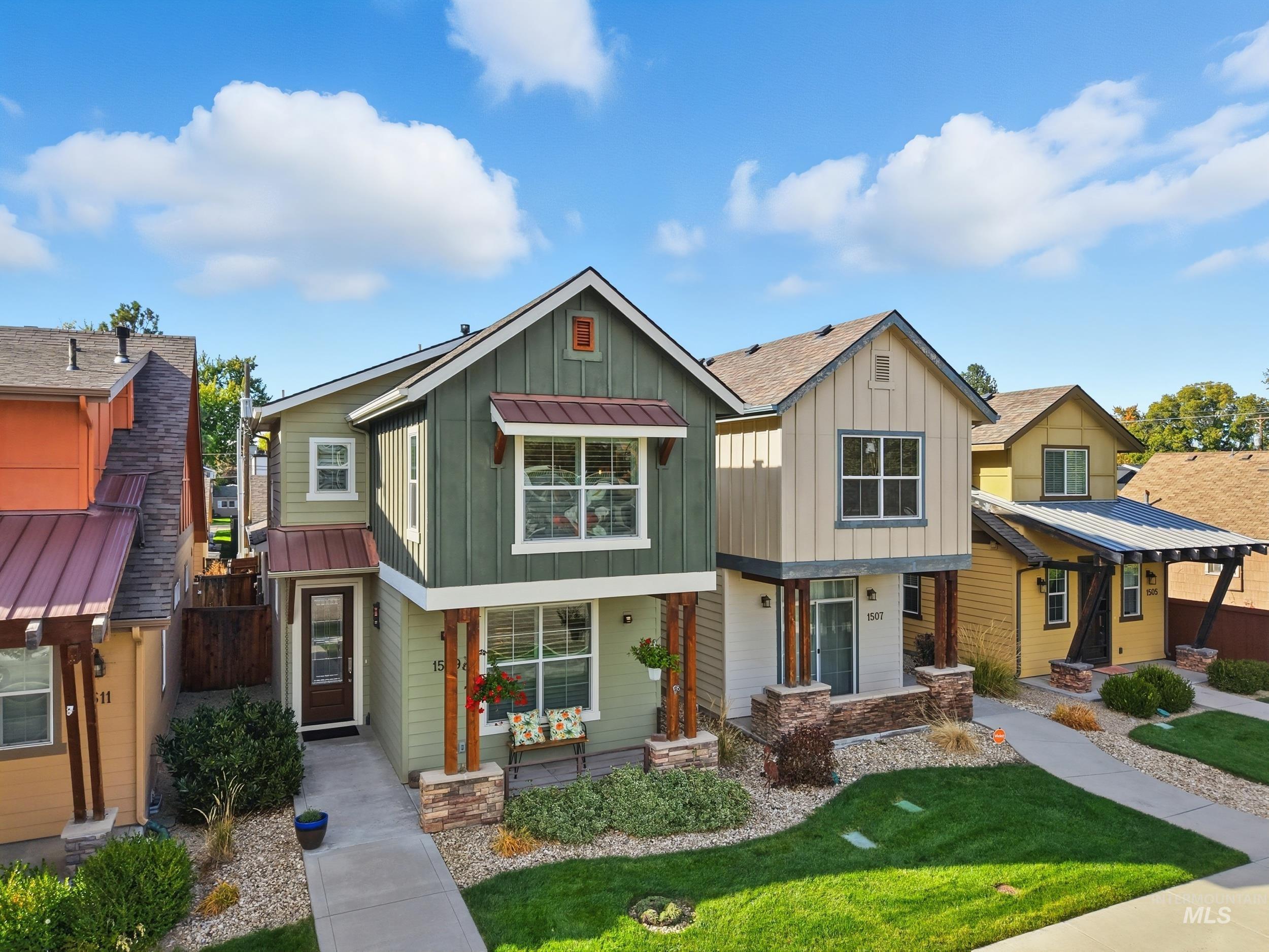 Craftsman house with board and batten siding, a porch, and a front lawn