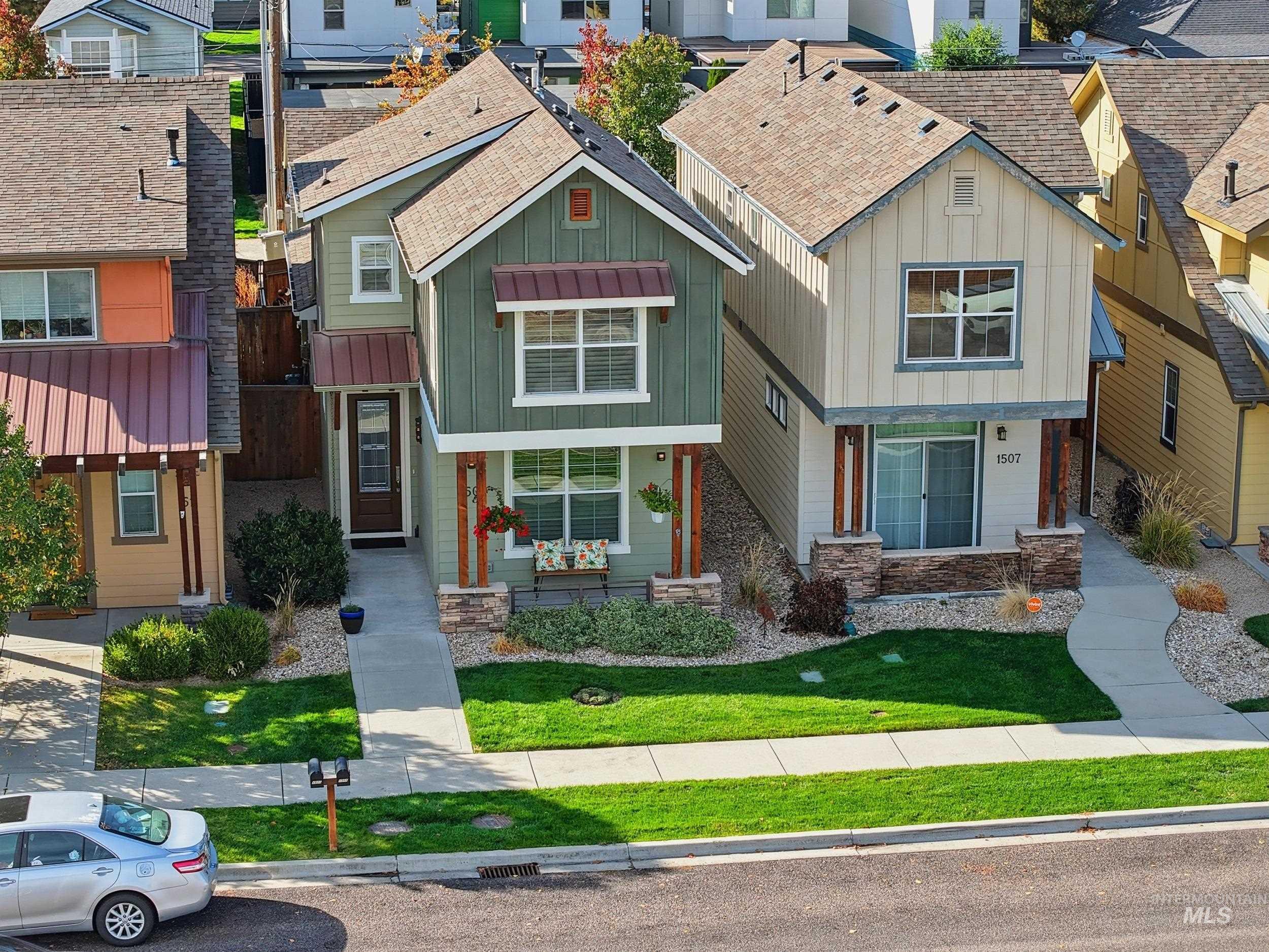 View of front of home featuring board and batten siding, roof with shingles, and a residential view