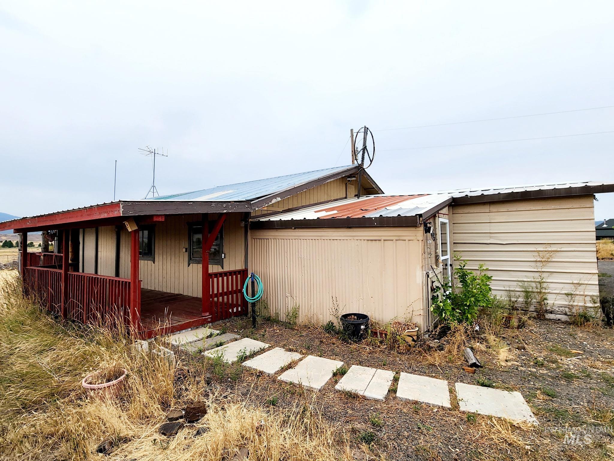 A covered porch welcomes you into the guest house mudroom, all while framing amazing mountain views
