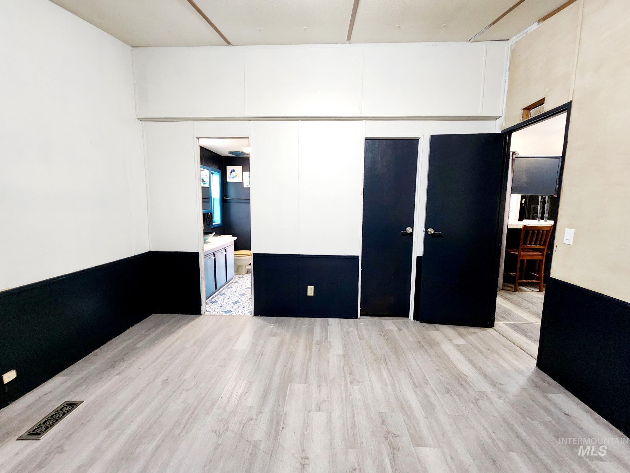 The main bedroom flows toward the bathroom and includes a small walk-in closet for convenience.