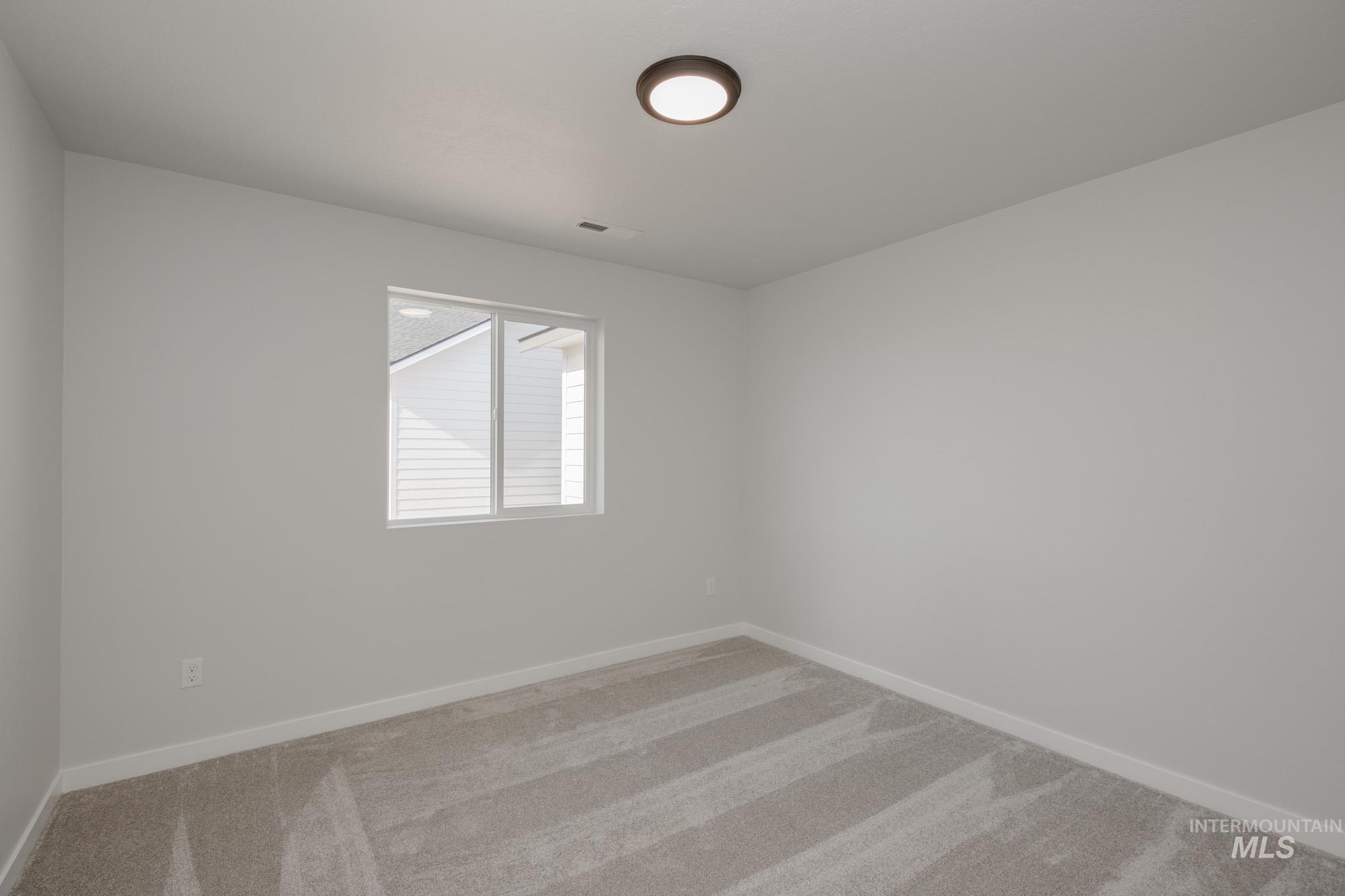 Unfurnished room with carpet