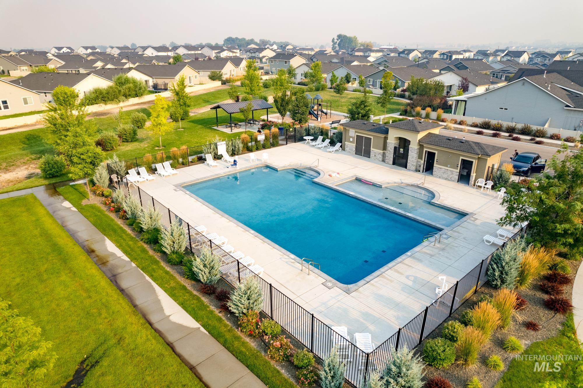 Community pool featuring a patio area and a residential view